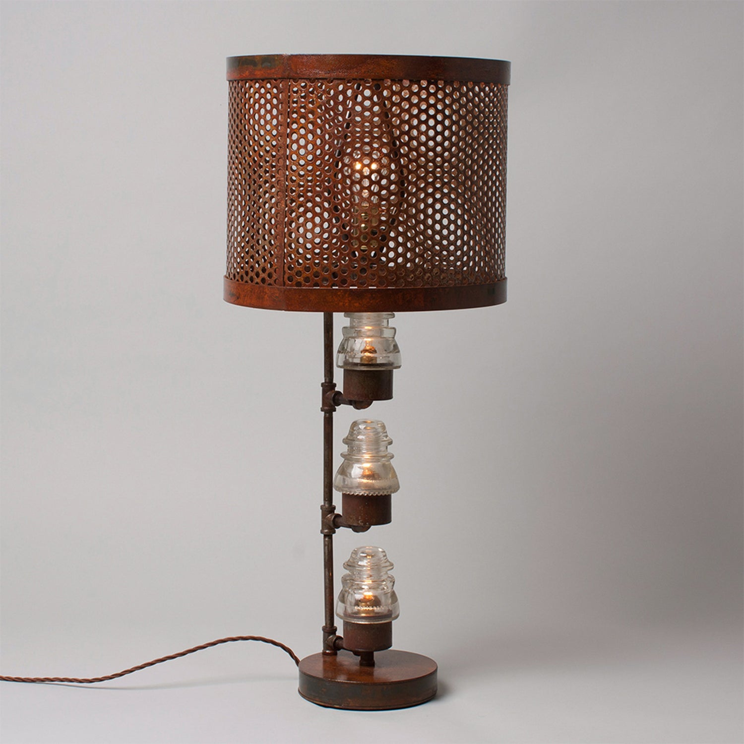 A traditional Hester & Cook Telegraph Table Top Lamp with a metal shade and a basket on top.