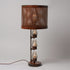 A traditional Hester & Cook Telegraph Table Top Lamp with a metal shade and a basket on top.
