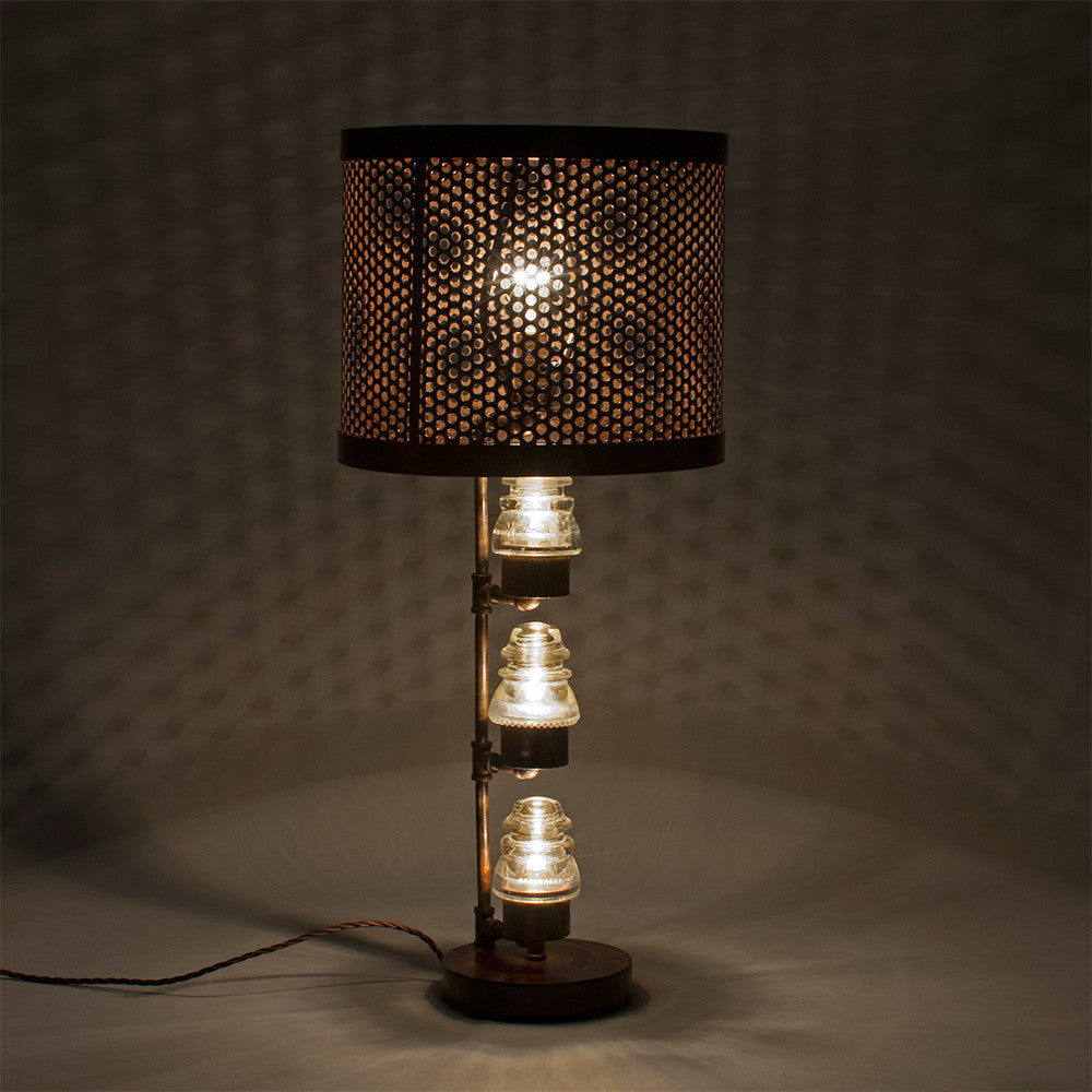 A traditional Hester & Cook Telegraph Table Top Lamp with a metal shade and a basket on top.