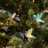 3 assorted colors of Glass Hummingbird Ornaments clipped into a tree. 
