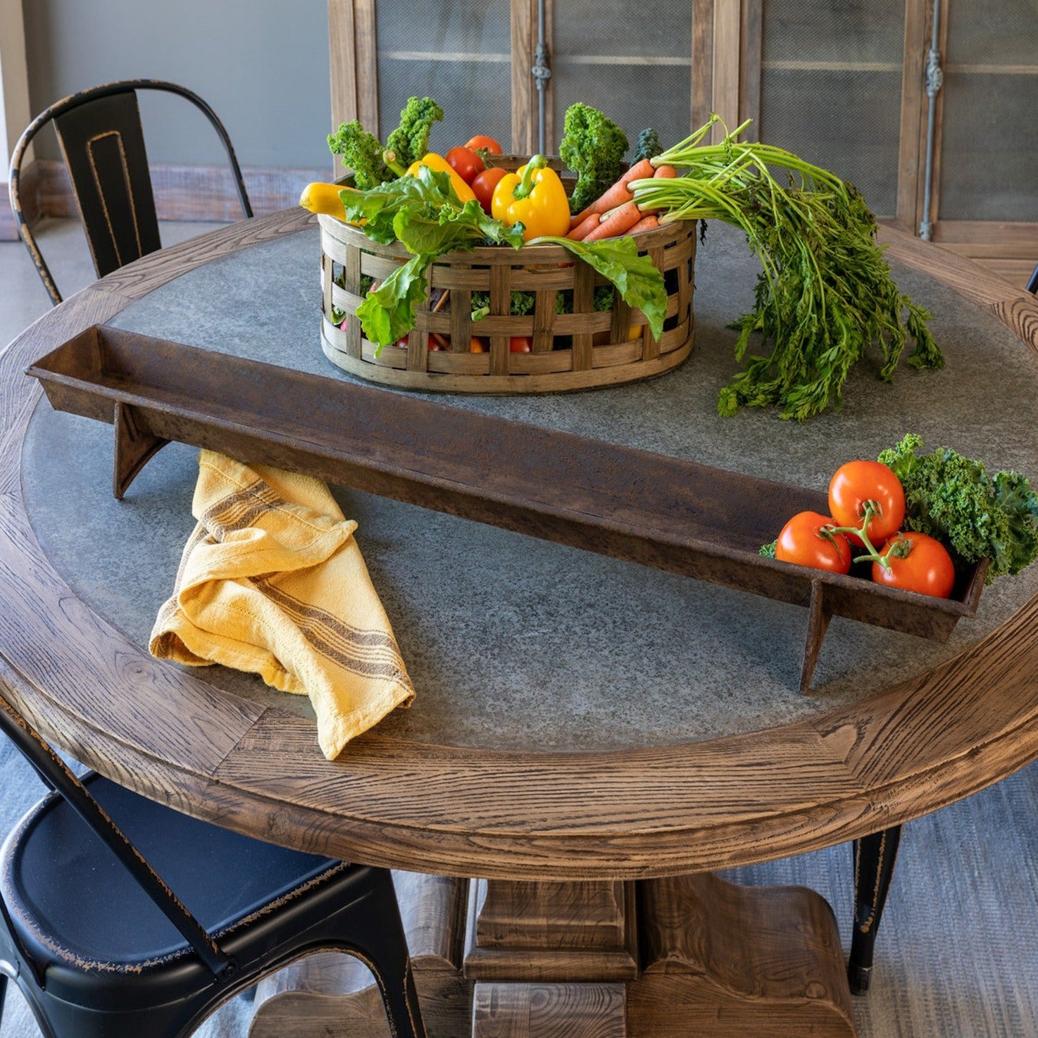 A table with a tray of vegetables on it, featuring a Park Hill Chicken Feeder Centerpiece in rustic style as the centerpiece.