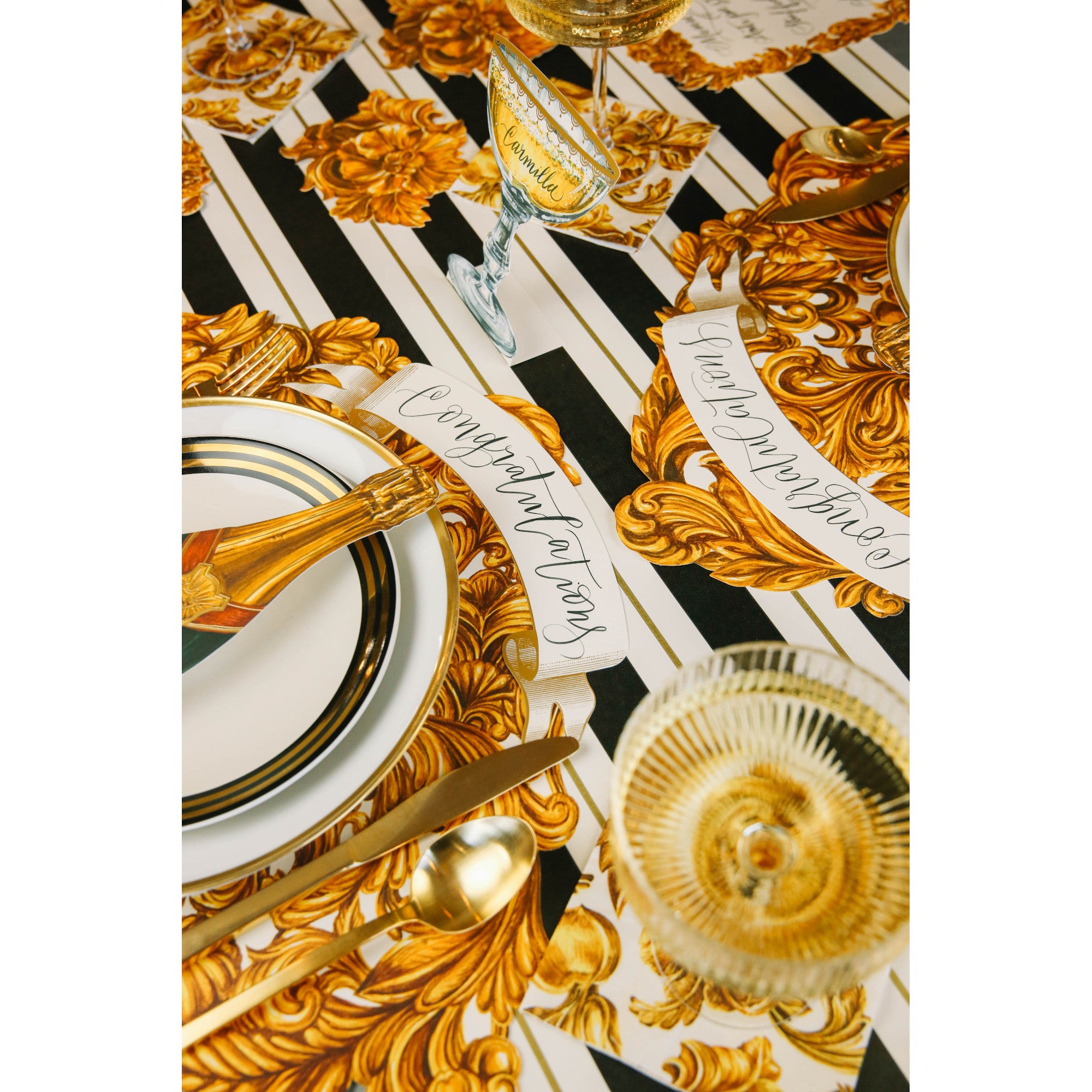The Black & Gold Awning Stripe Runner under an elegant gold-motif table setting.