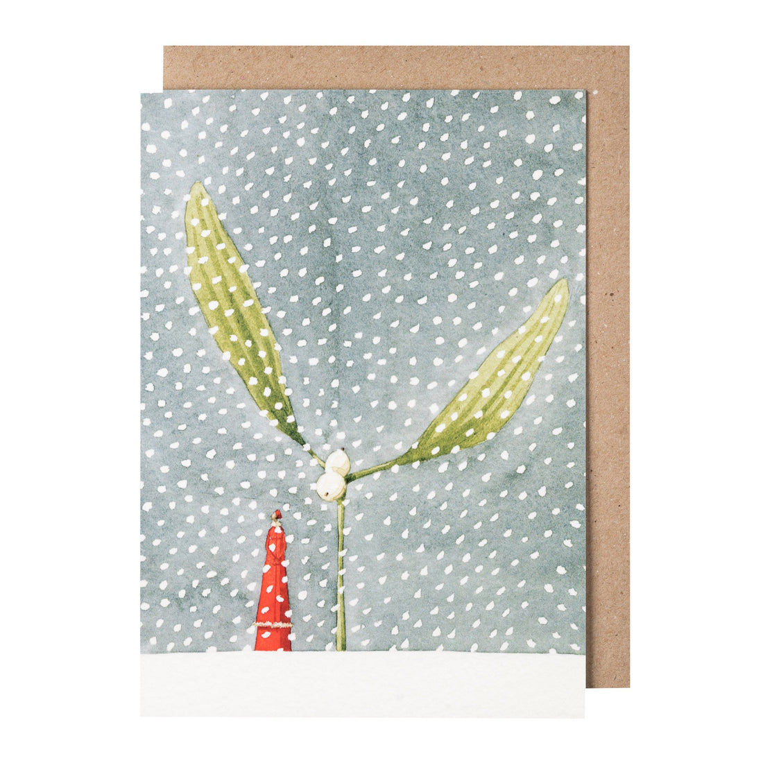 A greeting card featuring a whimsical illustration of a green sprig of mistletoe growing from a snowy plane, next to a small woman dressed in red, with a pattern of white snowflakes covering the image. Kraft paper envelope included.