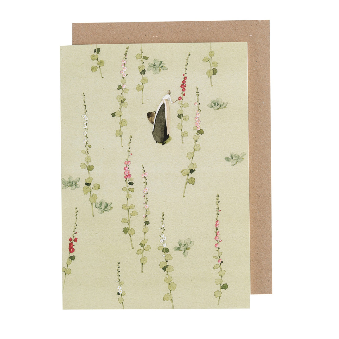 A sage green greeting card featuring a woman walking through a garden of red, pink and white hollyhock blooms, with the included kraft paper envelope.
