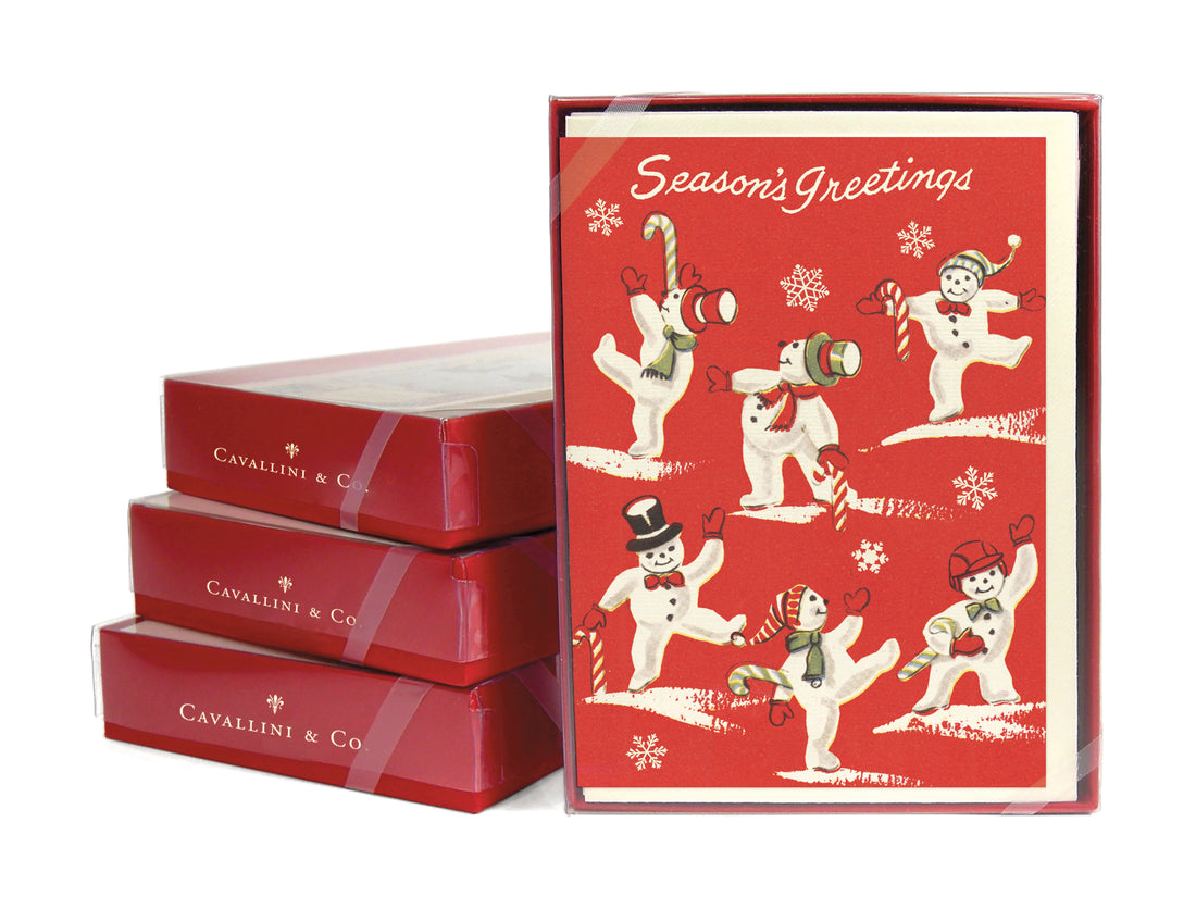 A boxed set of Cavallini &amp; Co. notecards featuring a red background with white snowmen and Christmas greetings design, including 10 folded notecards and envelopes.