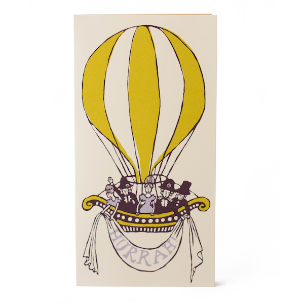 A greeting card with an illustration of a yellow hot air balloon with a basket full of people, printed in a hand-mixed color on a cream background.