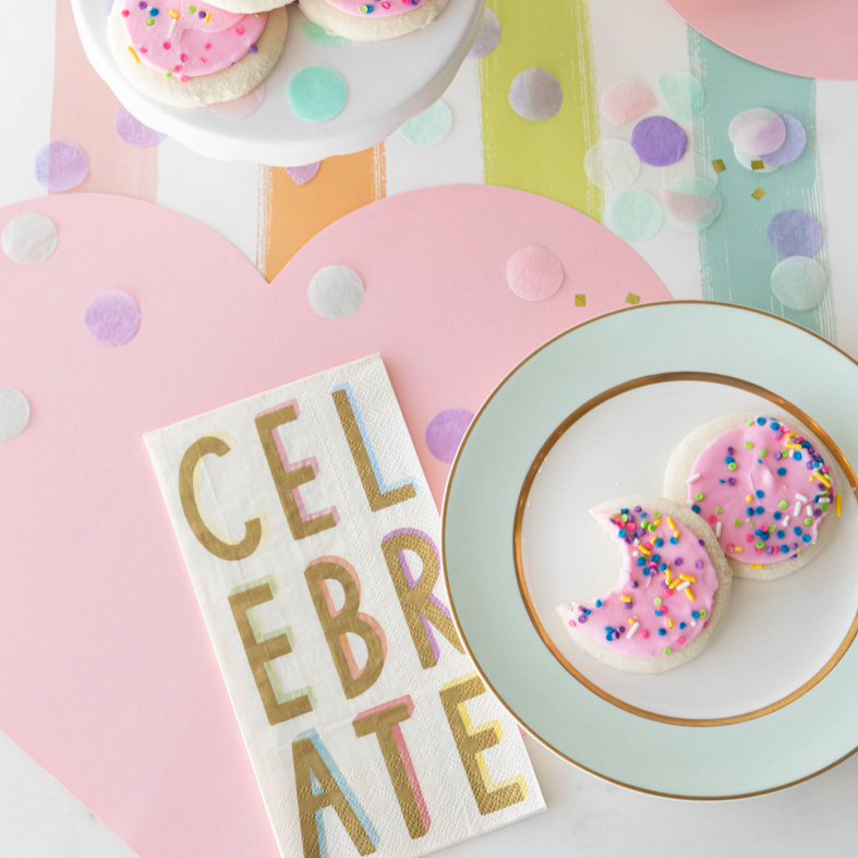 A table setting with a plate of Hester &amp; Cook Die-cut Pink Heart Placemat and confetti.