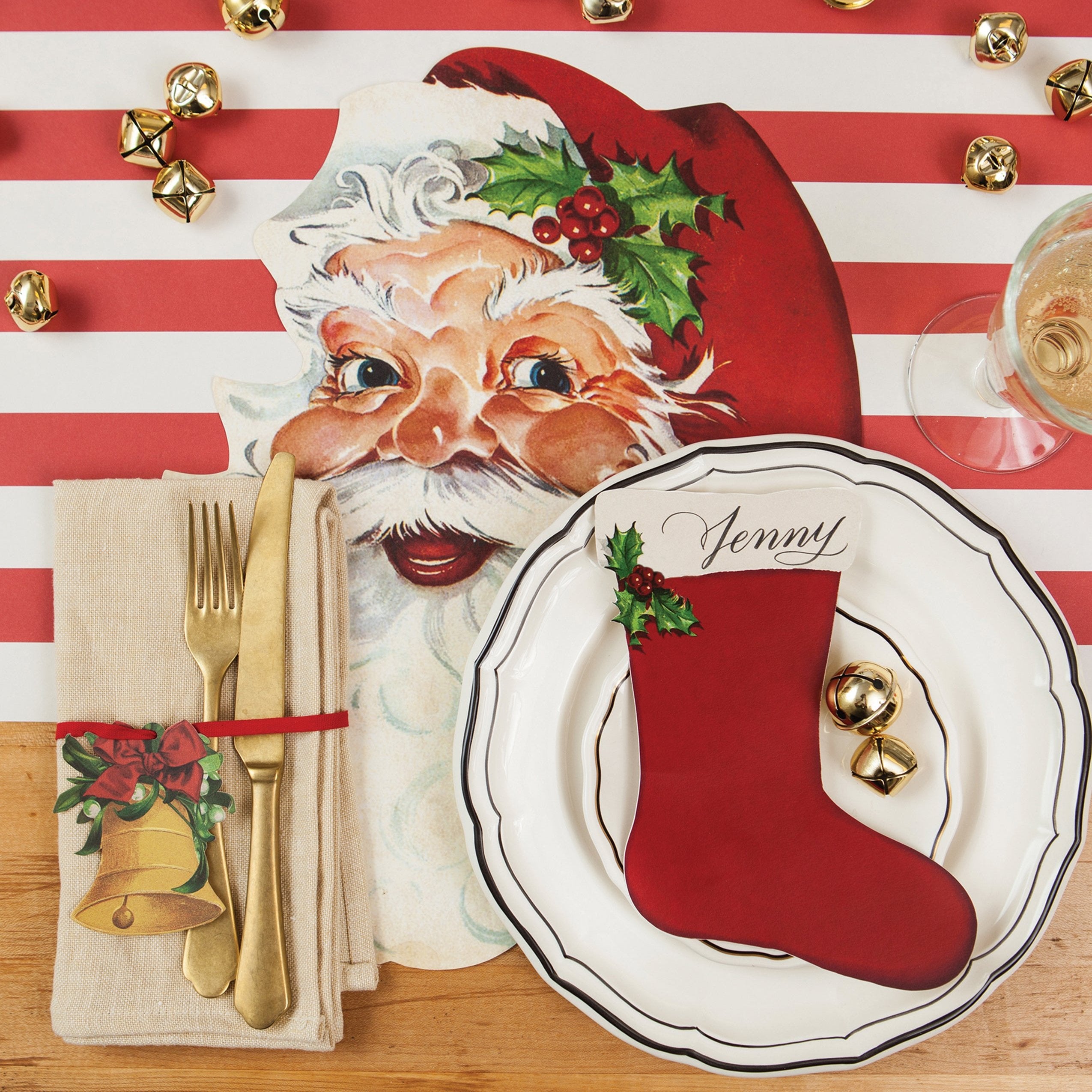 A festive Christmas place setting featuring a Stocking Table Accent labeled "Jenny" resting on the plate.