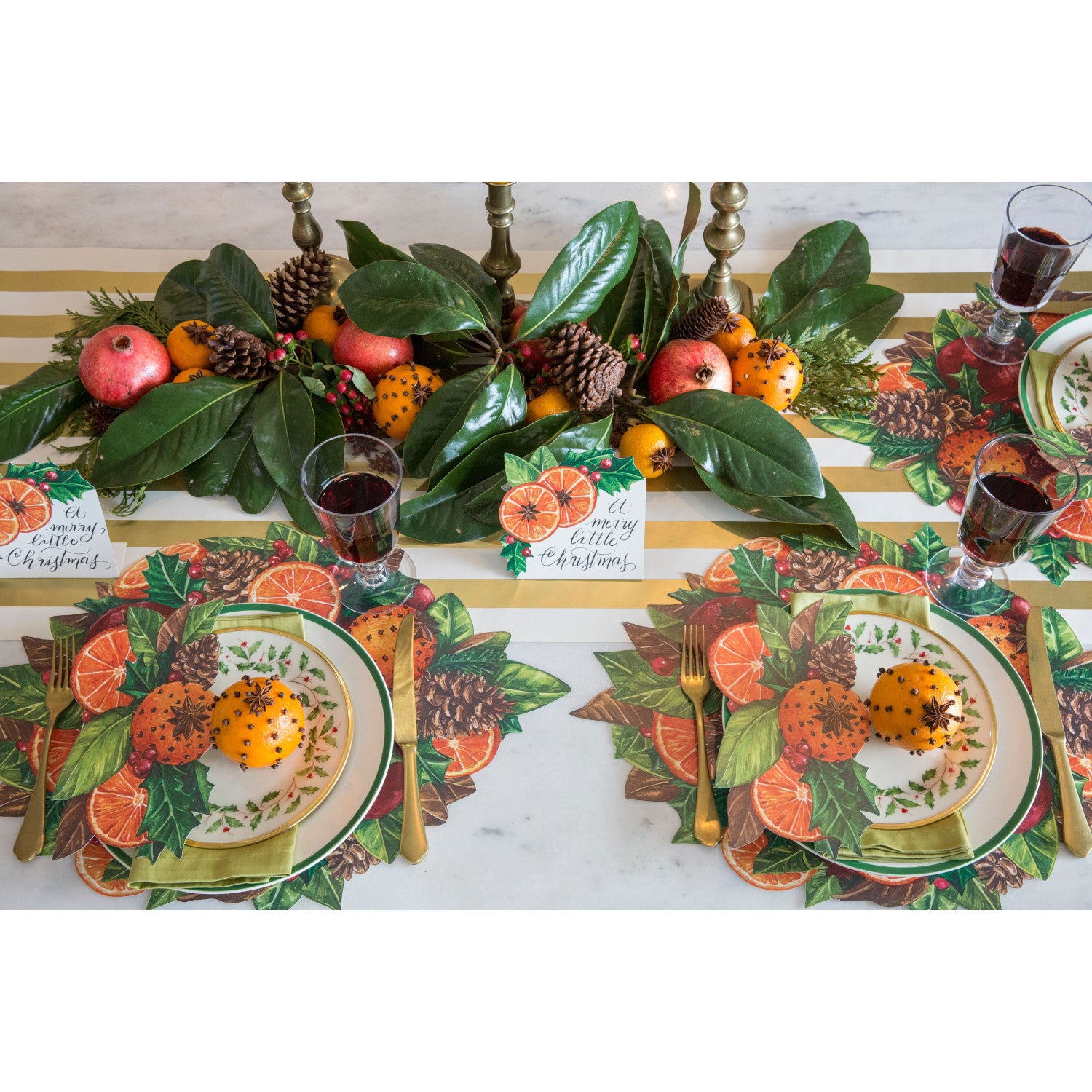 An elegant holiday table setting featuring Citrus Spice Place Cards reading "A Very Merry Christmas" by each plate.