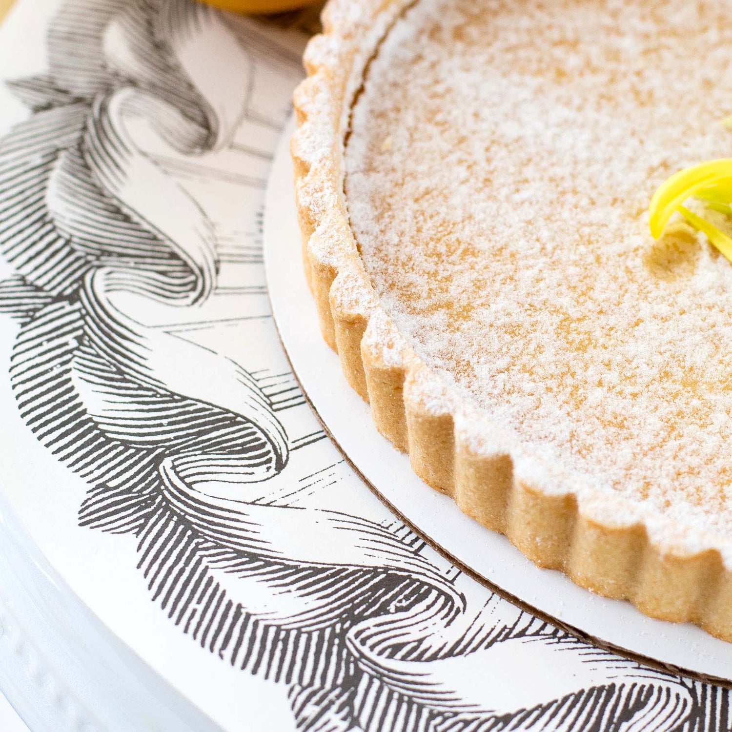 Close-up of a Rosette Serving Paper under a dessert, adding elegance to the tablescape.