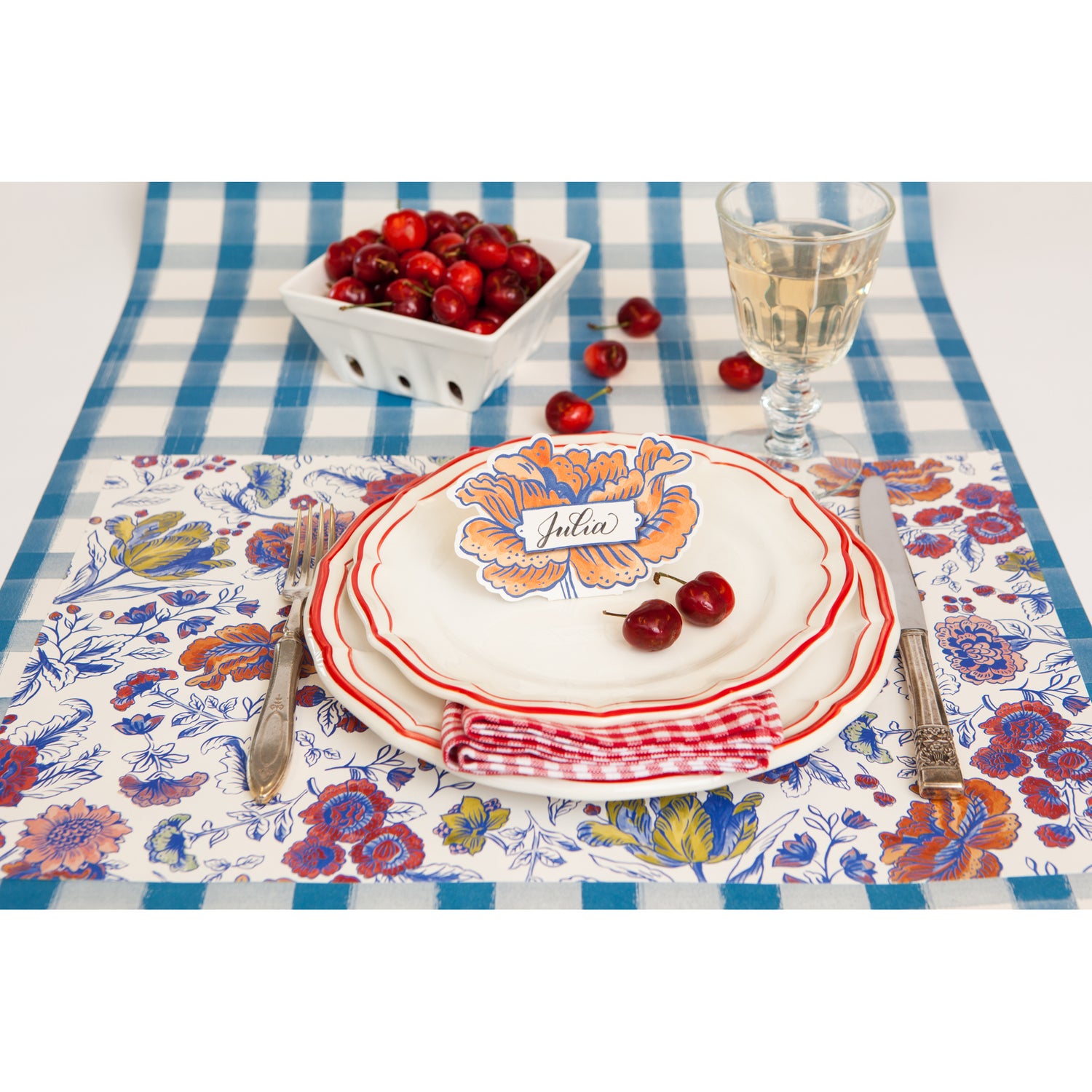 An elegant floral place setting featuring a Jardiniere Place Card labeled "Julia" standing on the plate.