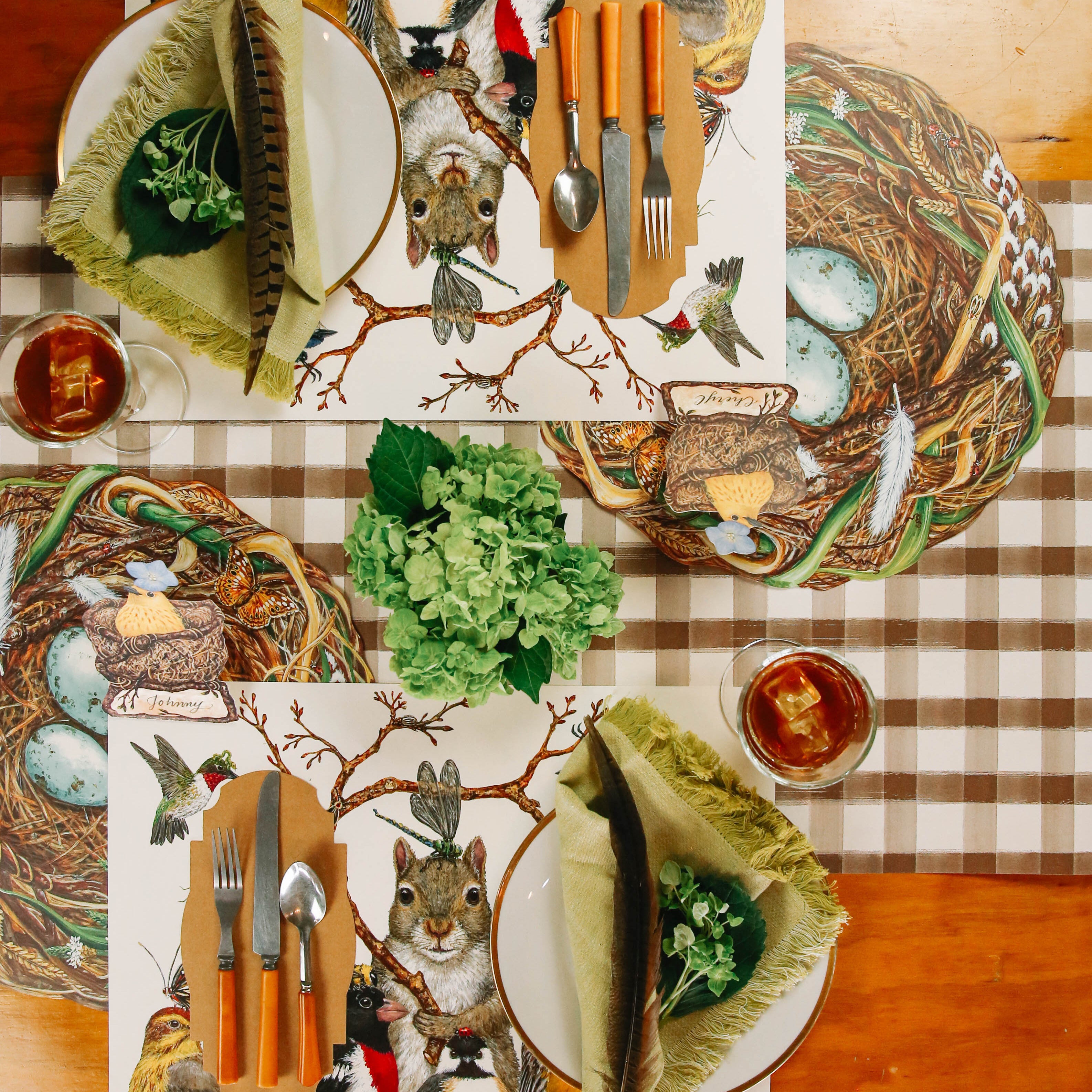 The Bug Day Afternoon Placemat under an elegant nature-themed table setting for two.