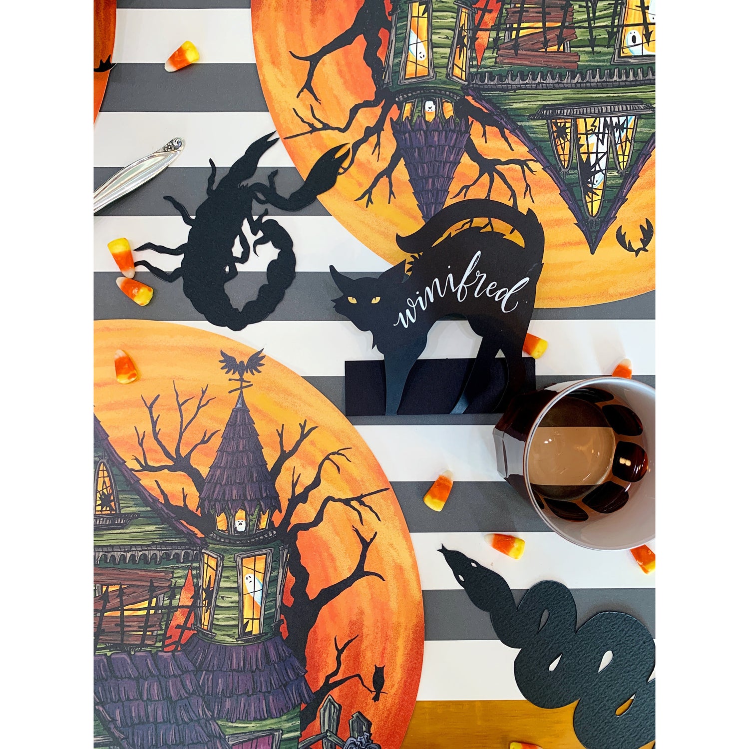 Die-cut, black paper cutouts of a rat, a snake, a spider and a scorpion.
