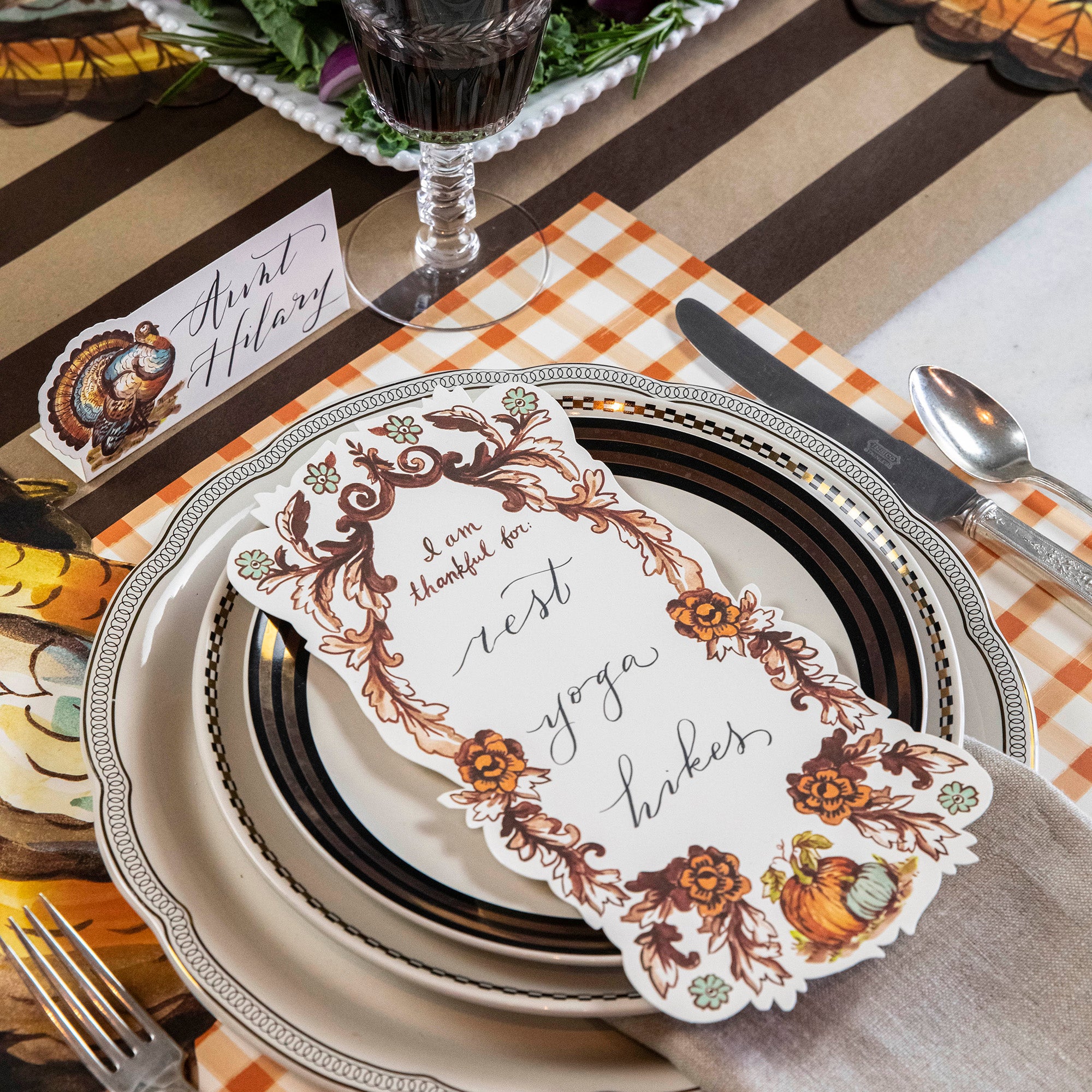 An "I Am Thankful For" Table Accent by Hester & Cook displayed on a plate, serving as a beautiful table accent.