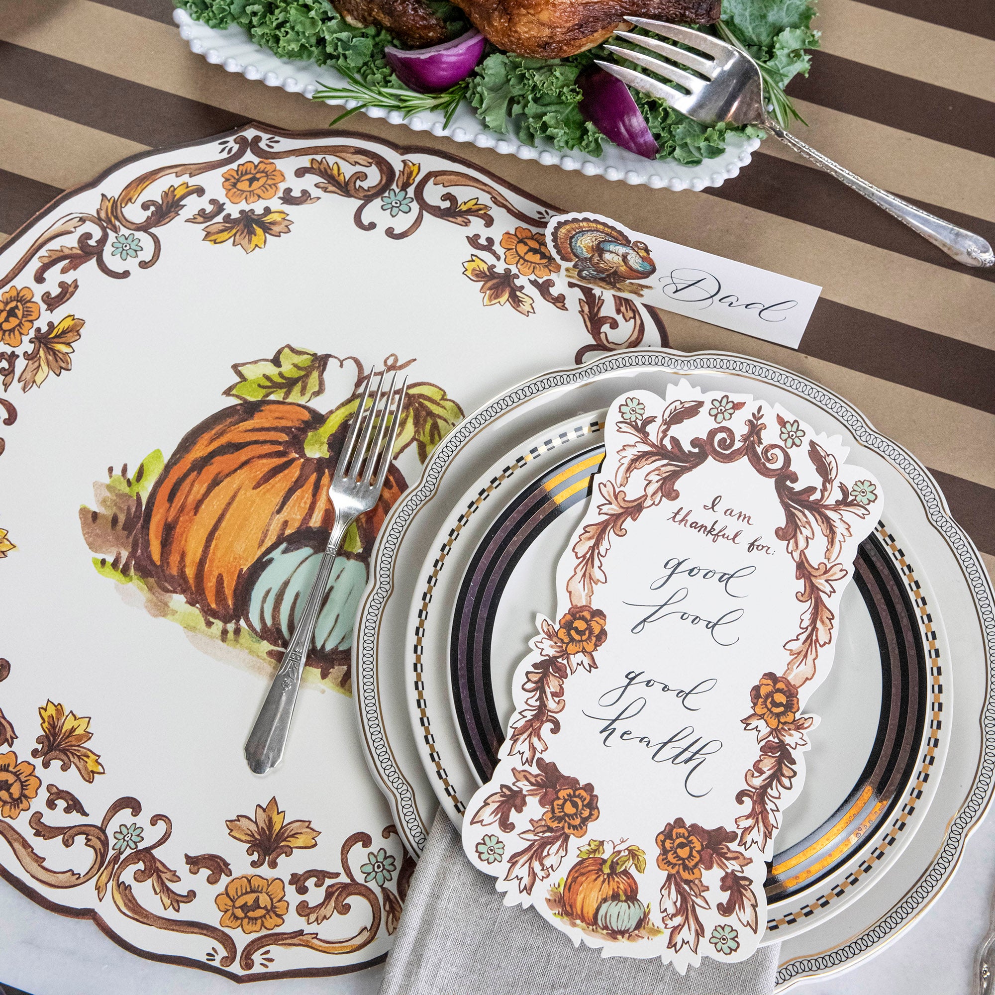 An elegant Thanksgiving place setting featuring an "I Am Thankful For" Table Accent resting on the plate.