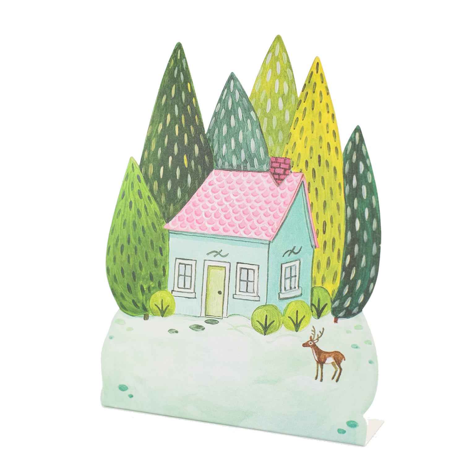 A die-cut freestanding place card featuring a whimsical illustration of a teal and pink house in a snowy field surrounded by tall green trees and a single deer, with the blank snow-covered front yard serving as a blank area for personalization.