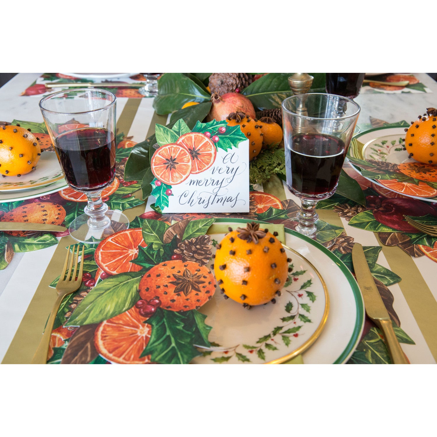An elegant holiday table setting featuring Citrus Spice Place Cards reading "A Very Merry Christmas" by each plate.