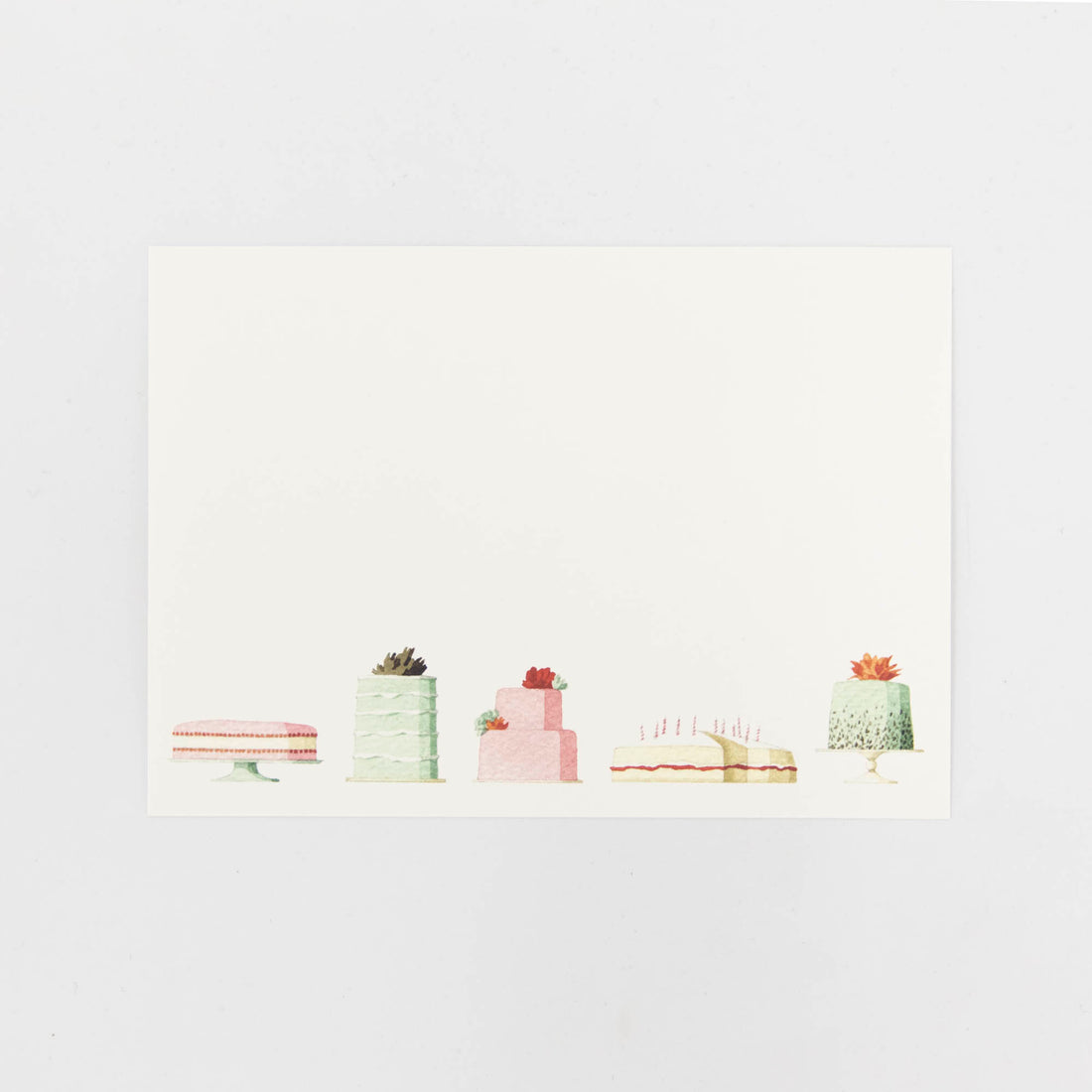 A Cakes Flat Notes card featuring an illustrated row of decadent cakes along the bottom of the white card.