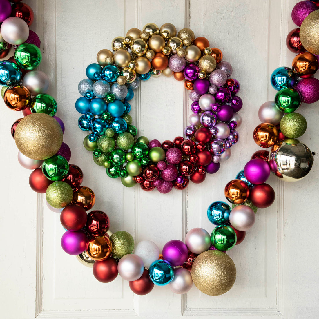 Collected Ornament Garland with oversized multicolored balls hanging with a corresponding wreath. 
