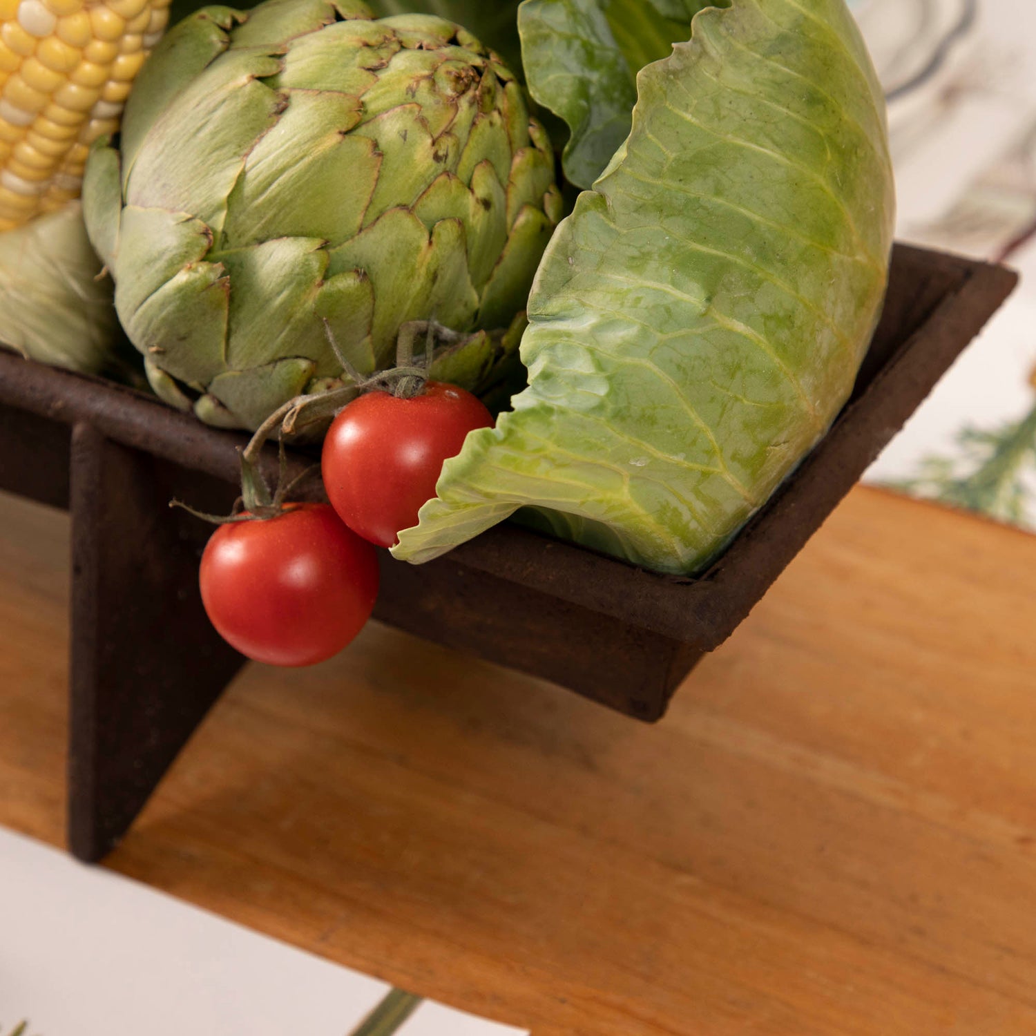 A table with a tray of vegetables on it, featuring a Park Hill Chicken Feeder Centerpiece in rustic style as the centerpiece.