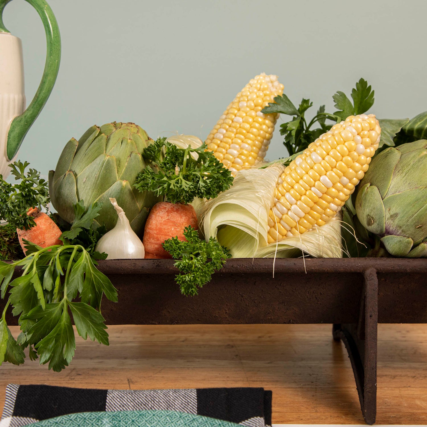 A table with a tray of vegetables on it, featuring a Park Hill Chicken Feeder Centerpiece in rustic style as the centerpiece.