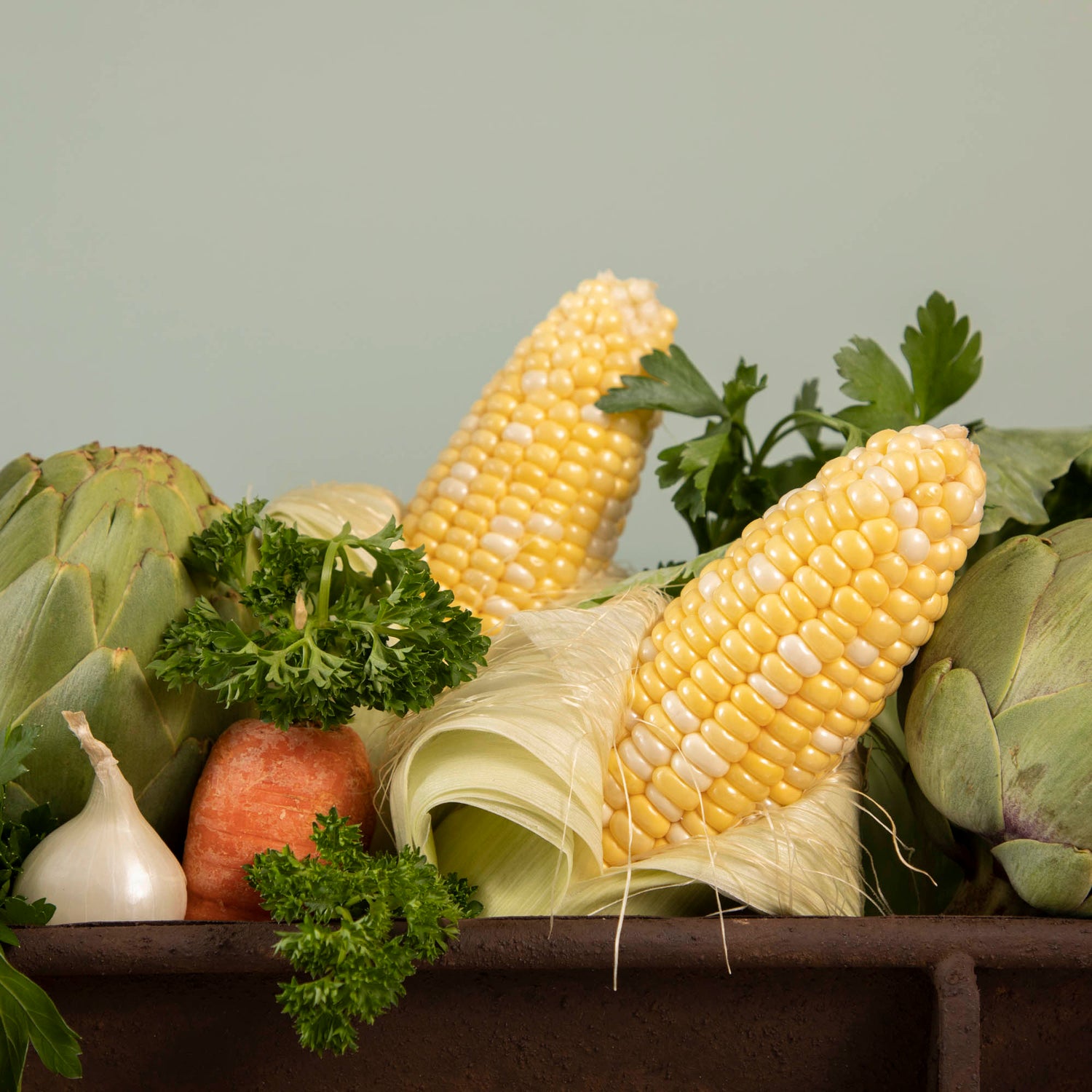 A table with a tray of vegetables on it, featuring a Park Hill Chicken Feeder Centerpiece in rustic style as the centerpiece.