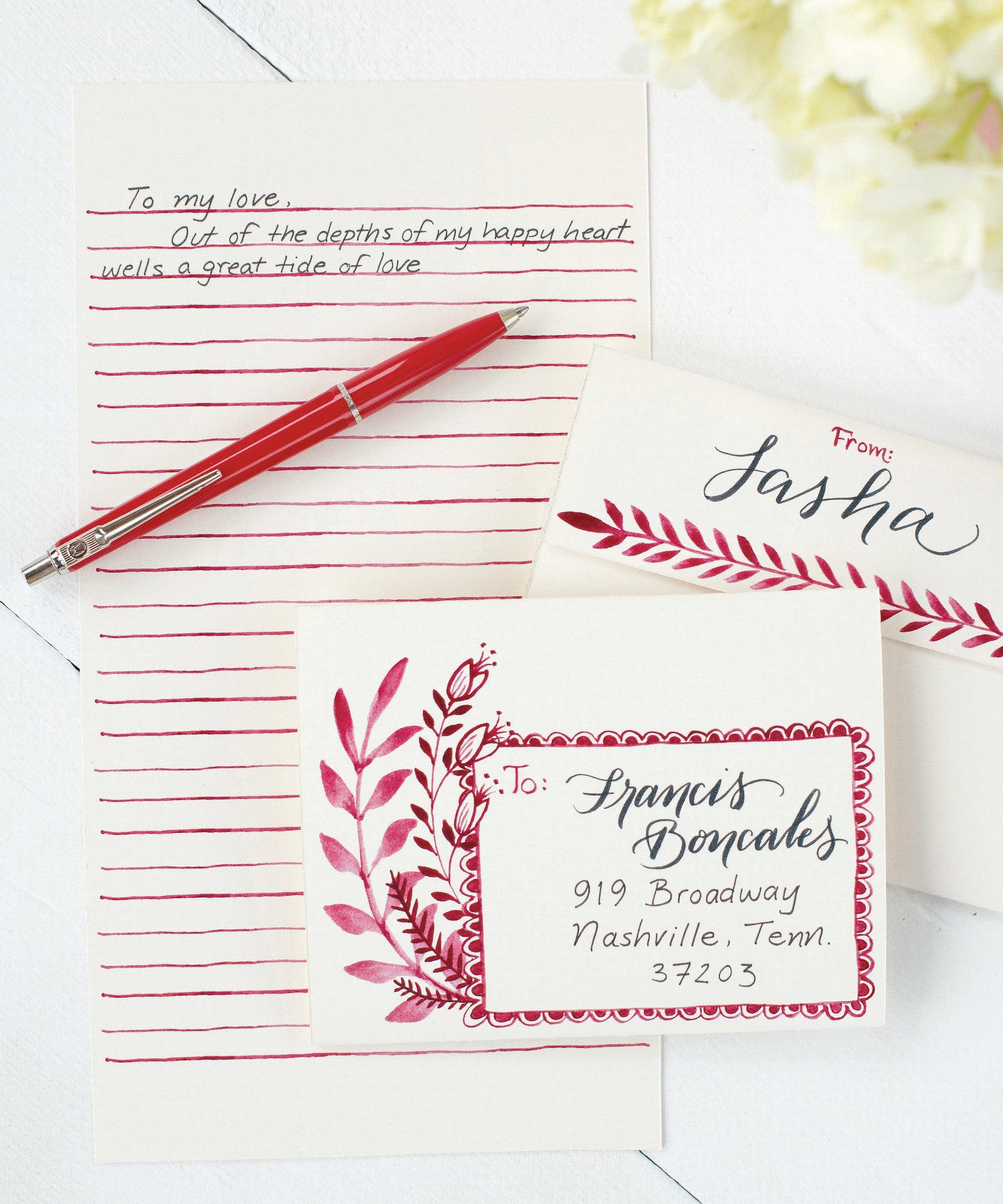 A Love Letter Fold Note Card with red flowers and leaves on a beige background, ready to fold and mail from Hester &amp; Cook.