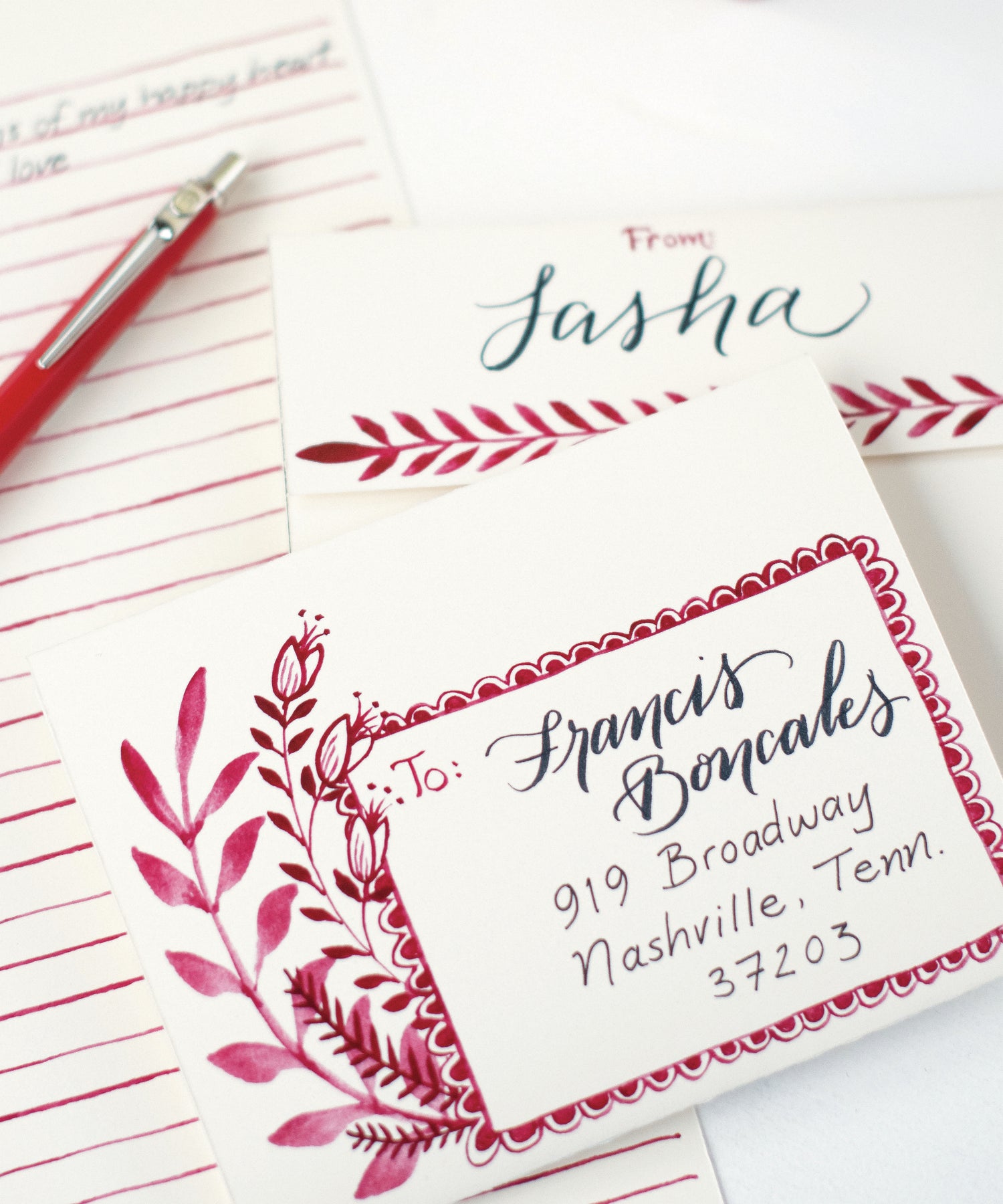 A Love Letter Fold Note Card with red flowers and leaves on a beige background, ready to fold and mail from Hester &amp; Cook.