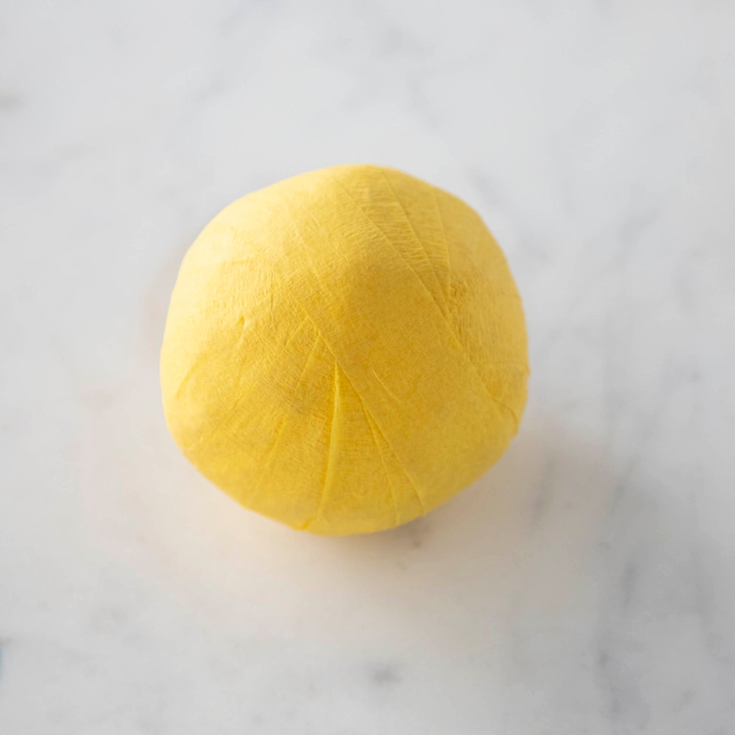 Vintage-inspired Mini Surprize Balls in a white bowl with confetti by Tops Malibu.