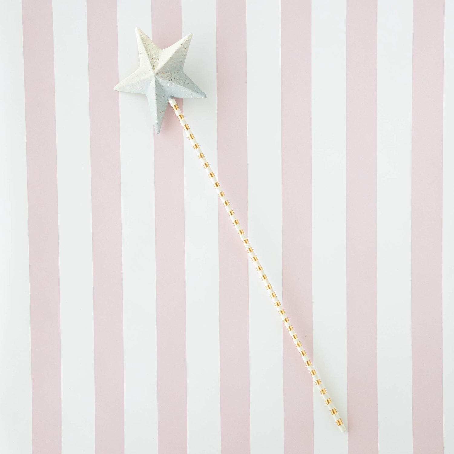 Five Glitterville Magic Wands on a striped background.