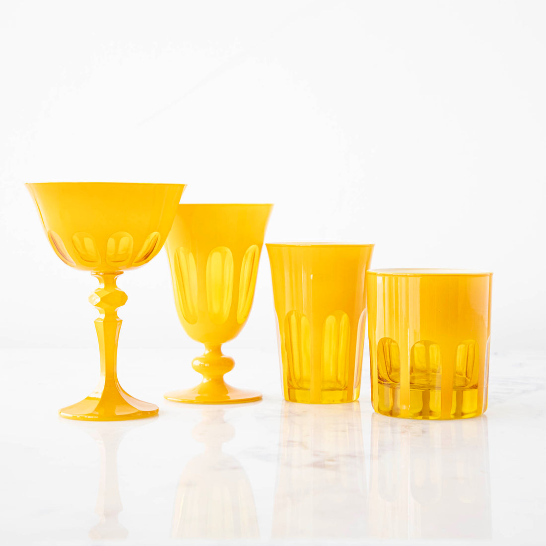 A set of Rialto Saffron Glasses by SIR/MADAM on a white surface.
