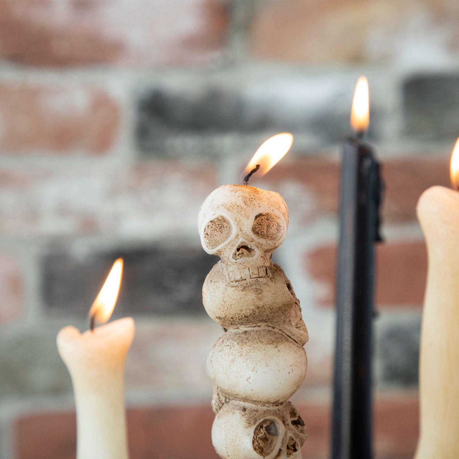 Close up of the stacked skulls shaped taper candle. 