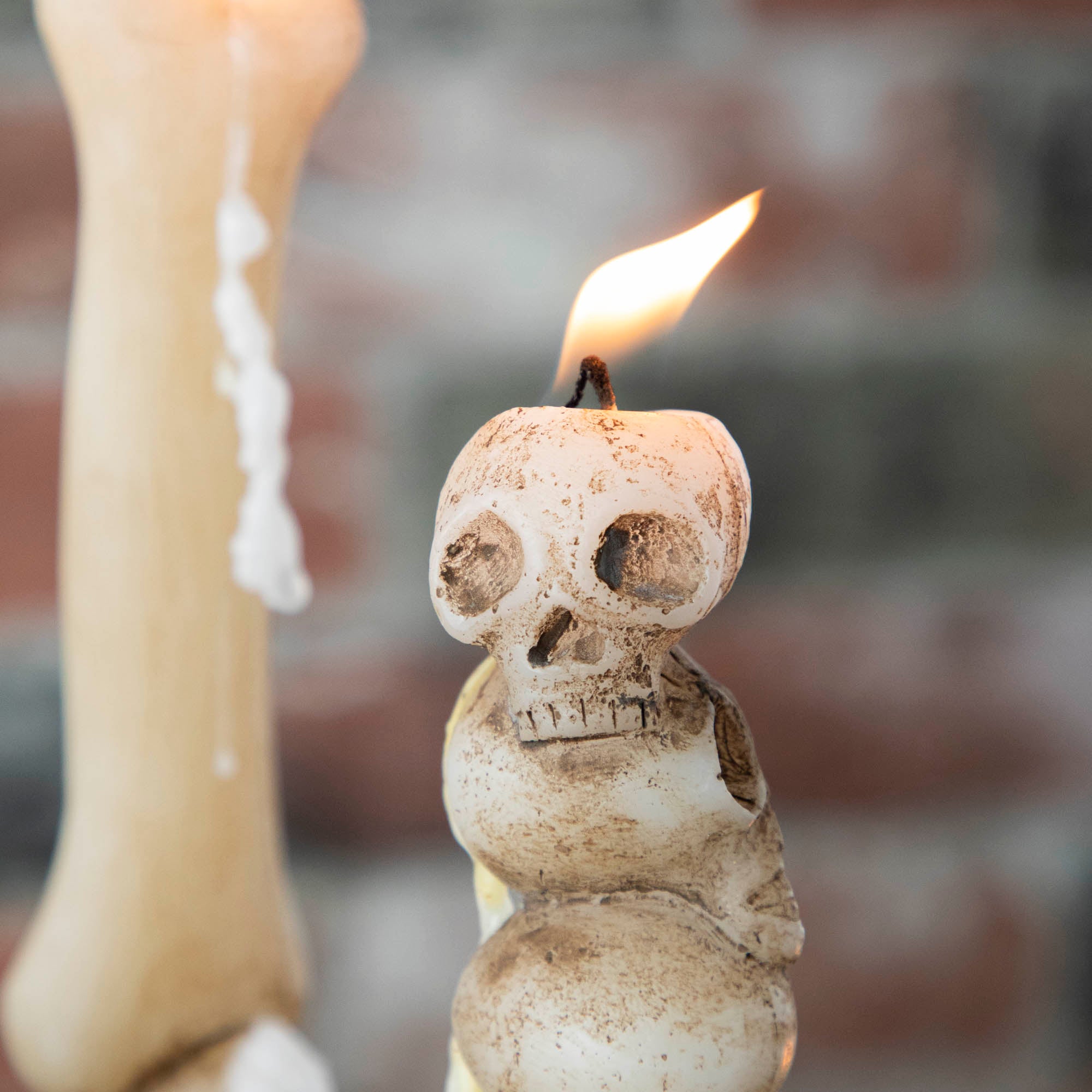 A close up of the stacked skull taper candle.