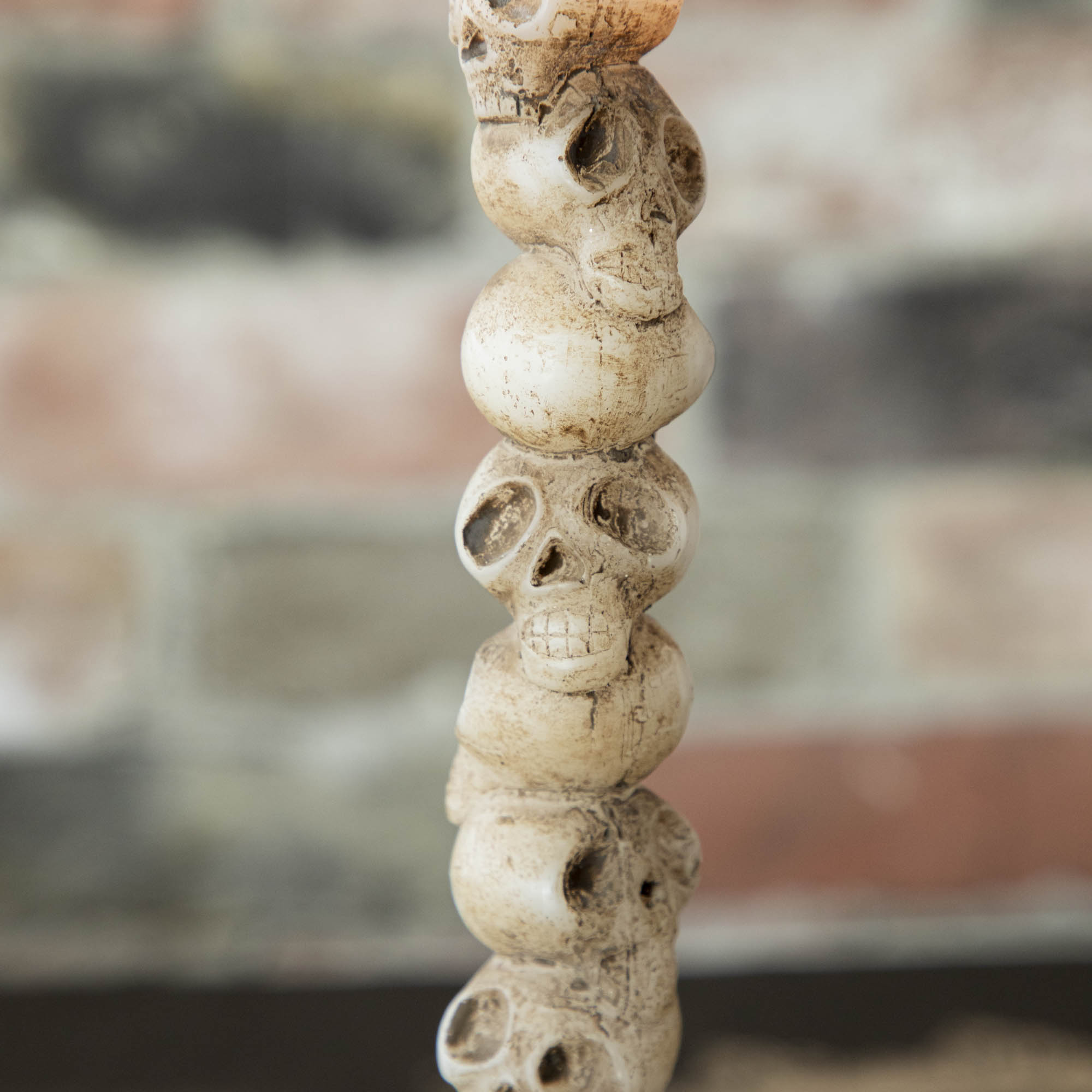 Close up of the stacked skulls shaped taper candle.