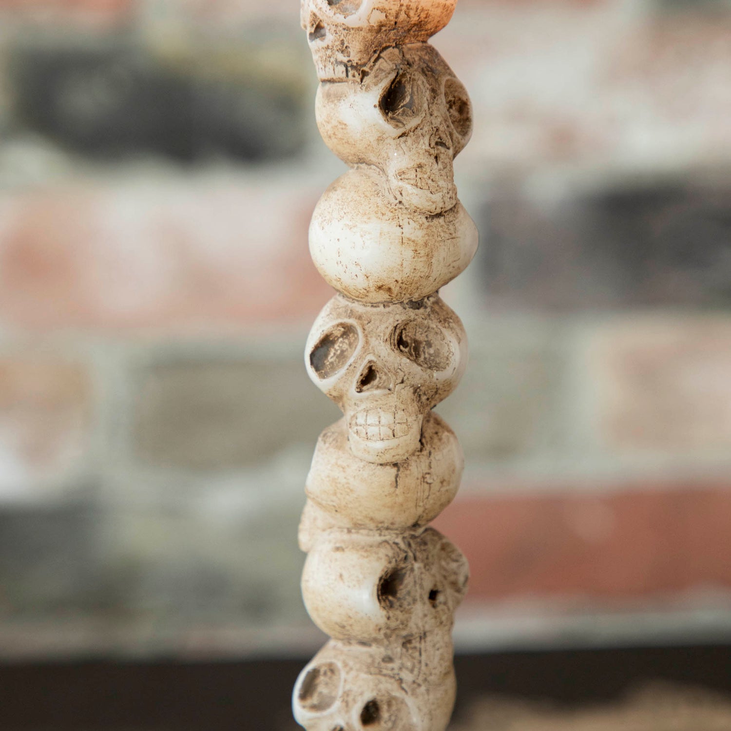 Close up of the stacked skulls shaped taper candle. 