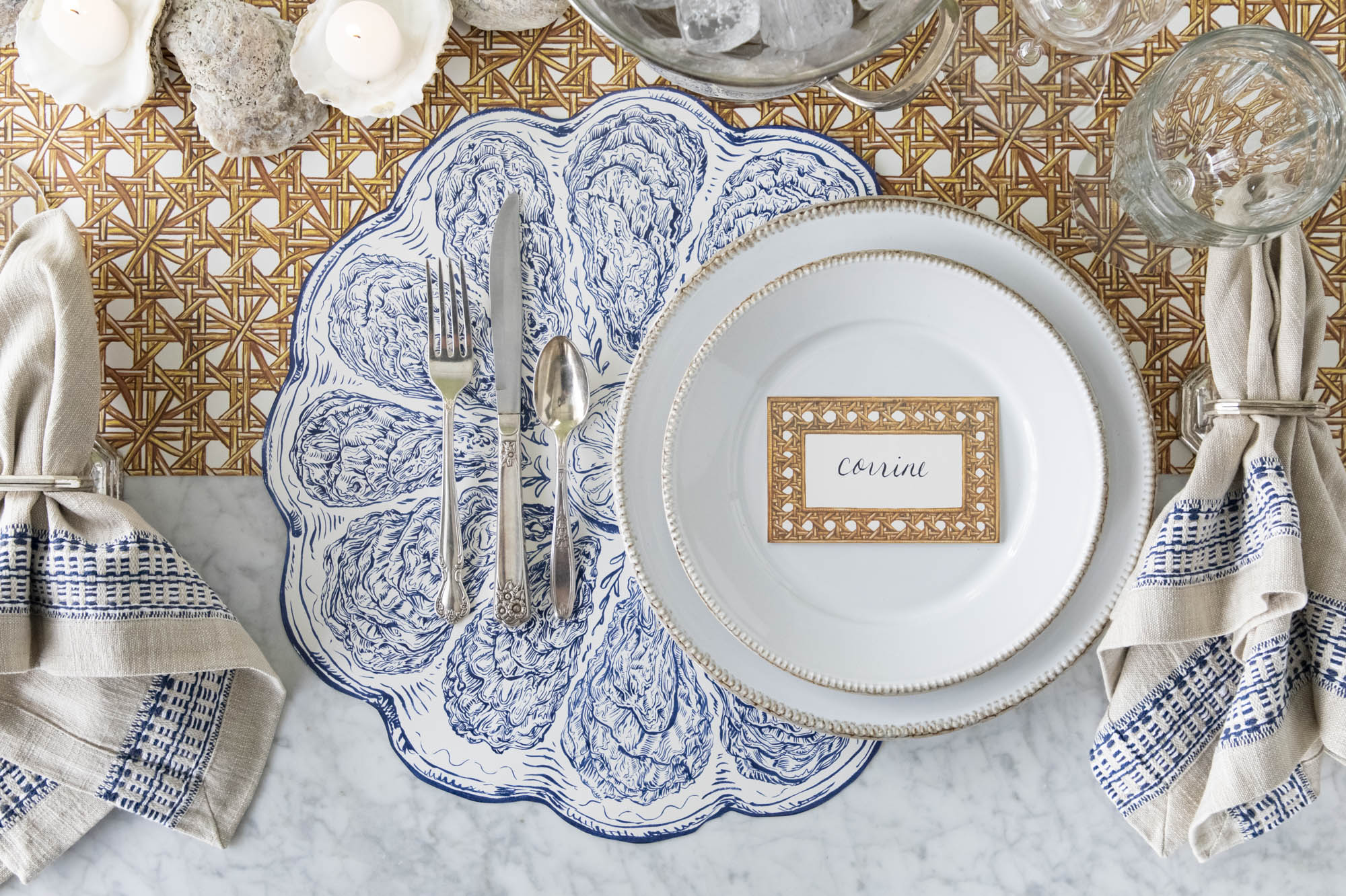 An elegant blue oyster themed place setting featuring items from the Blue Oyster Story.