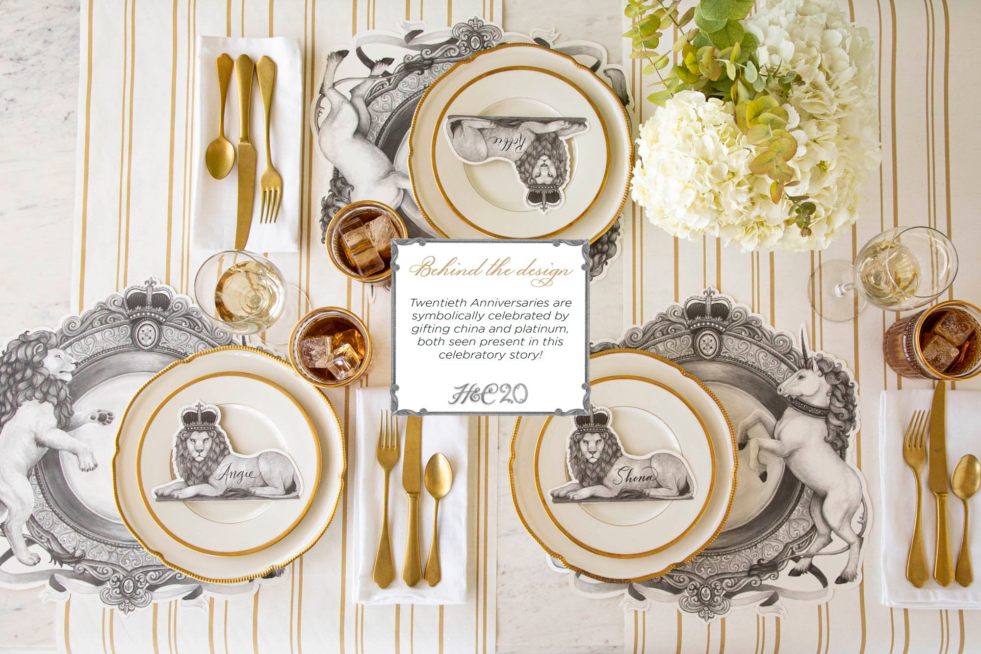 The Die-cut H&C Regal Crest Placemat and Regal Lion Place Card, styled elegantly on a table setting for three.