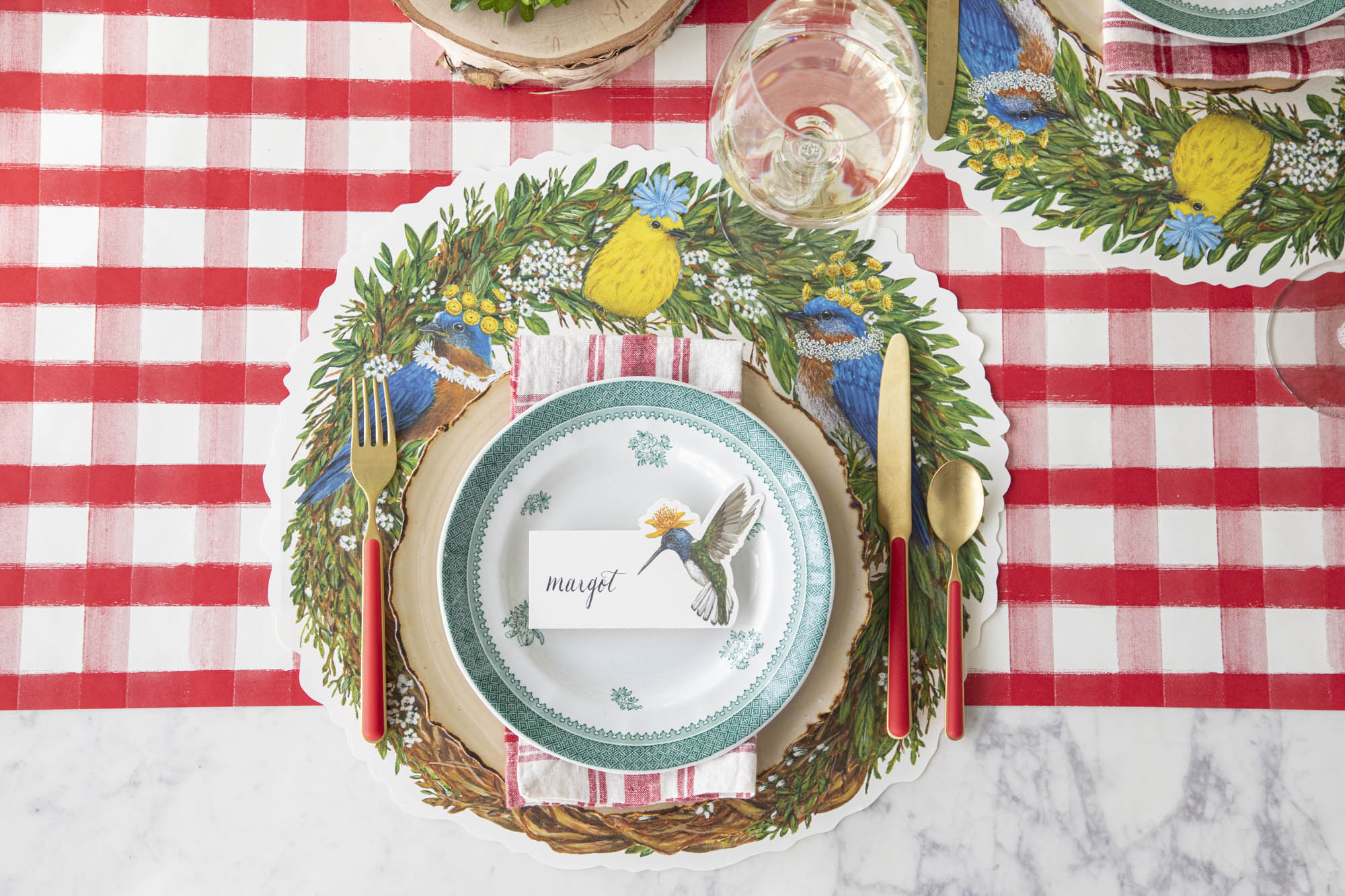 A garden party themed place setting featuring the Die-cut Songbird Wreath Placemat.