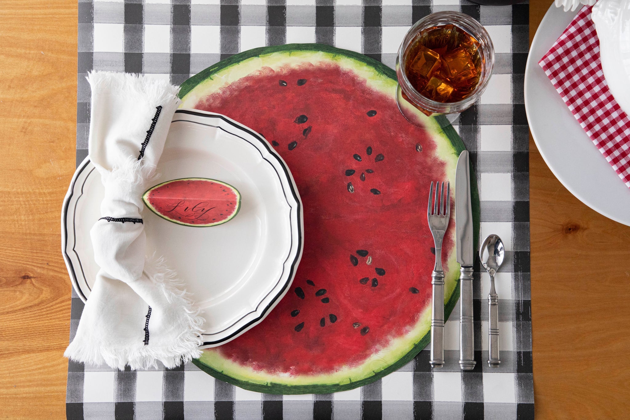Die-cut Watermelon Placemat under a place setting for one.