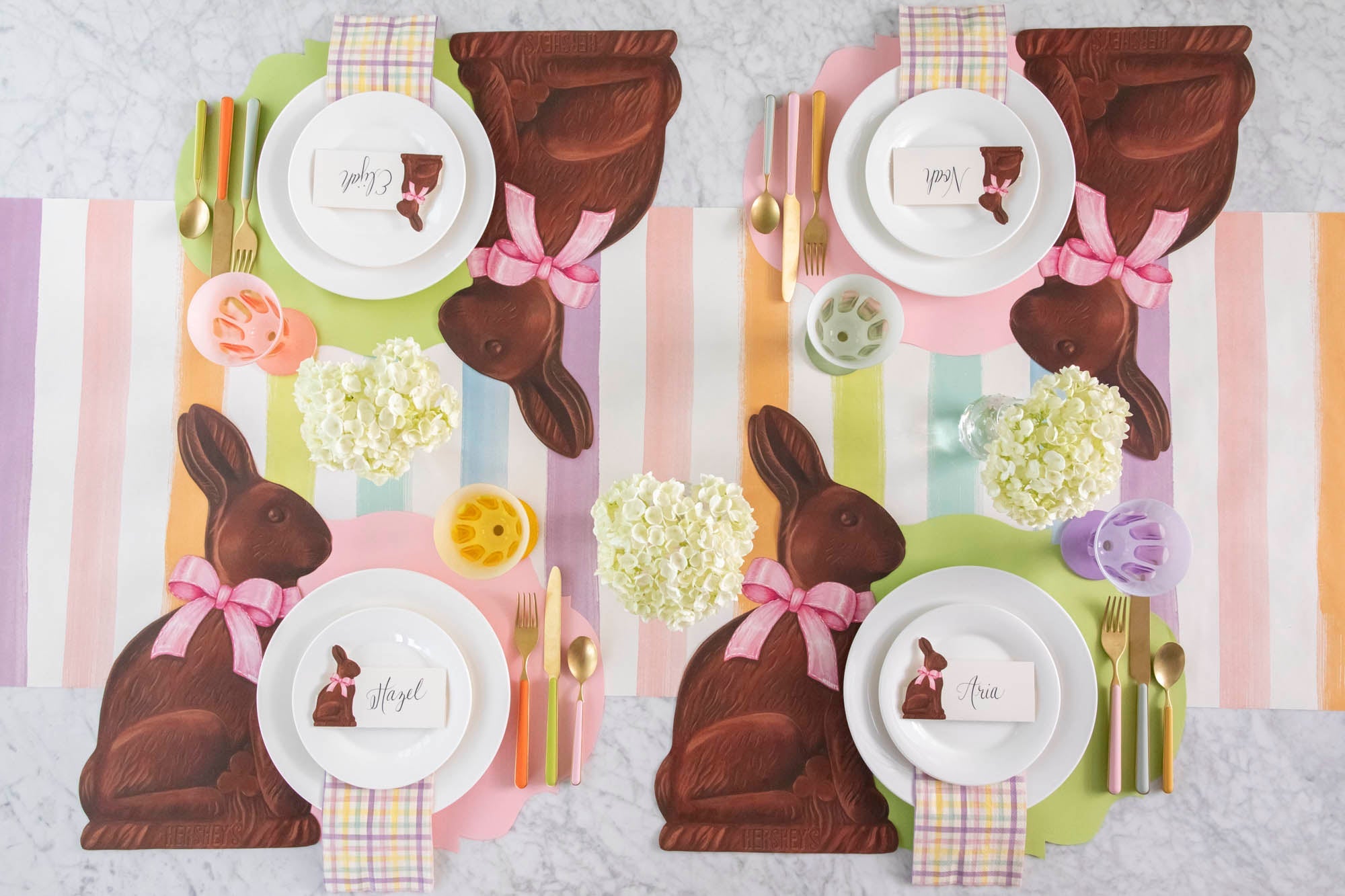 A brightly colored Easter table setting featuring the Die-cut Hershey's Chocolate Bunny Placemat and Sorbet Painted Stripe Runner.