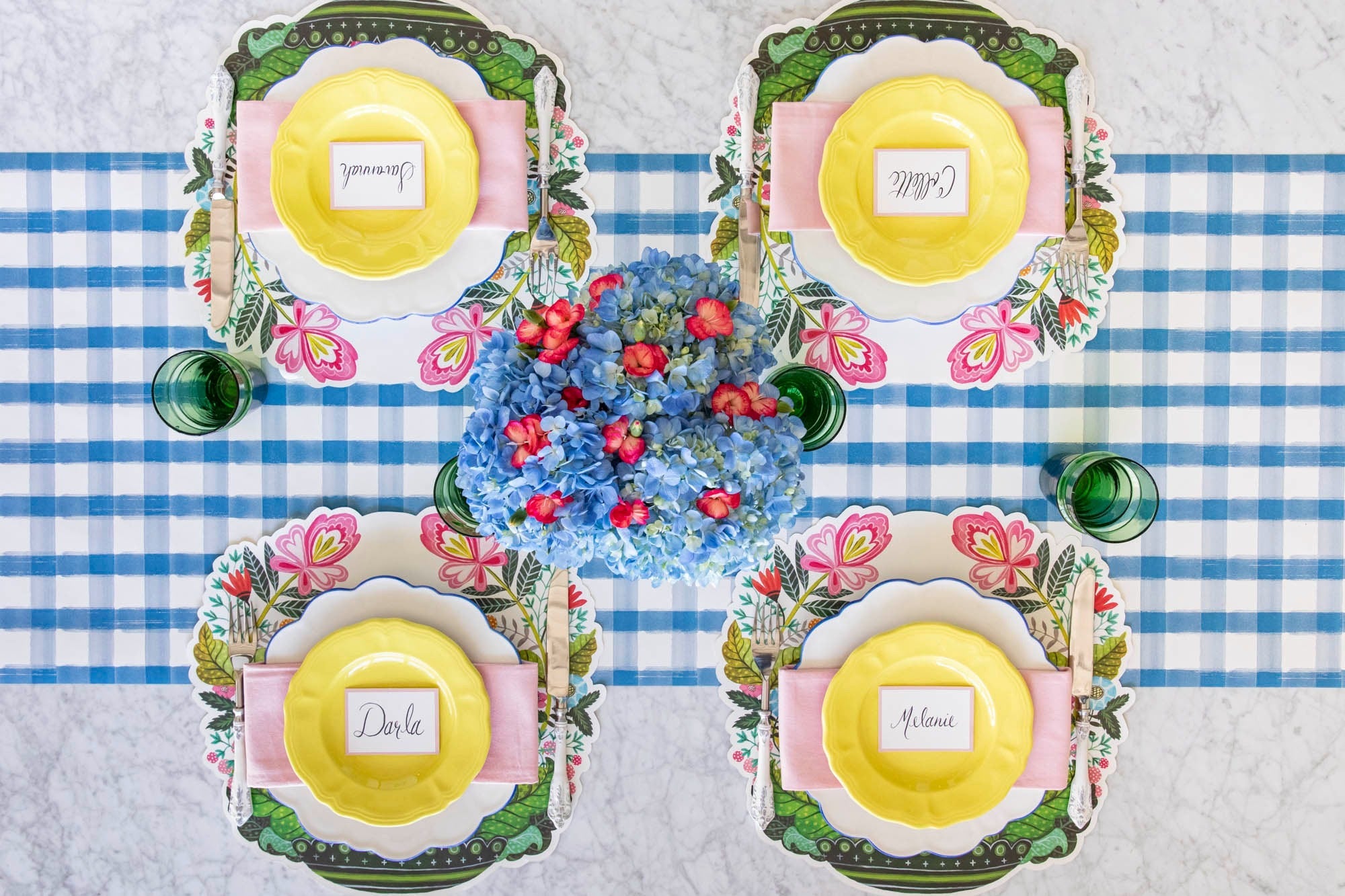 A spring table setting for four featuring vibrant flowers and the Die-cut Vase Arrangement Placemat.