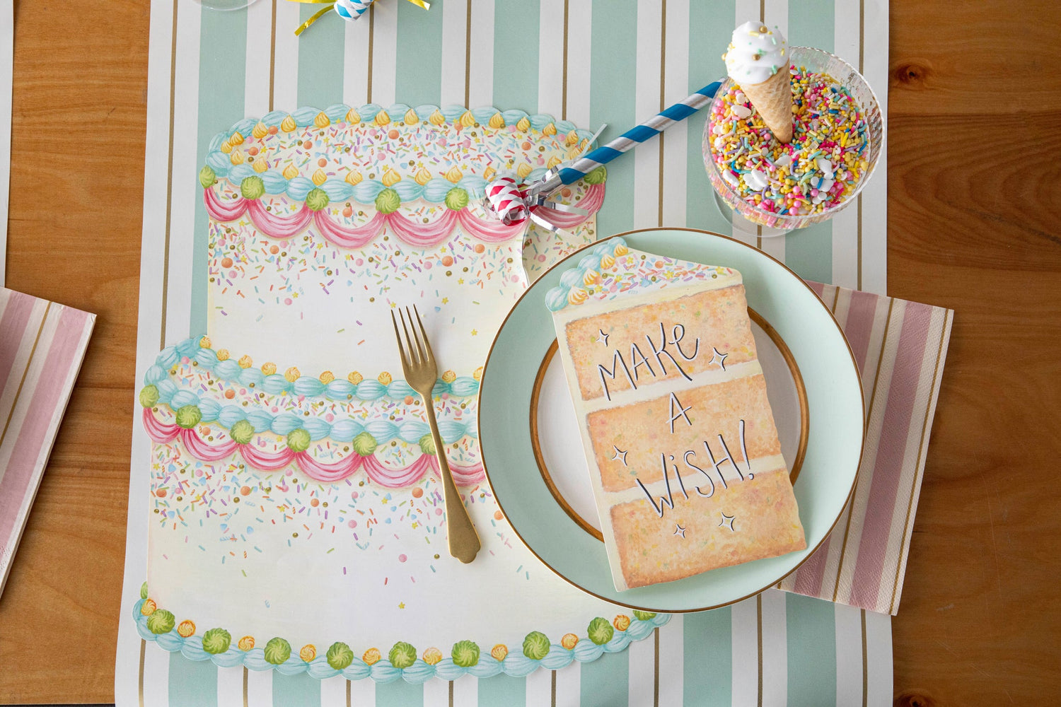 A birthday themed place setting featuring the Die-cut Birthday Cake Placemat and Cake Slice Table Accent.