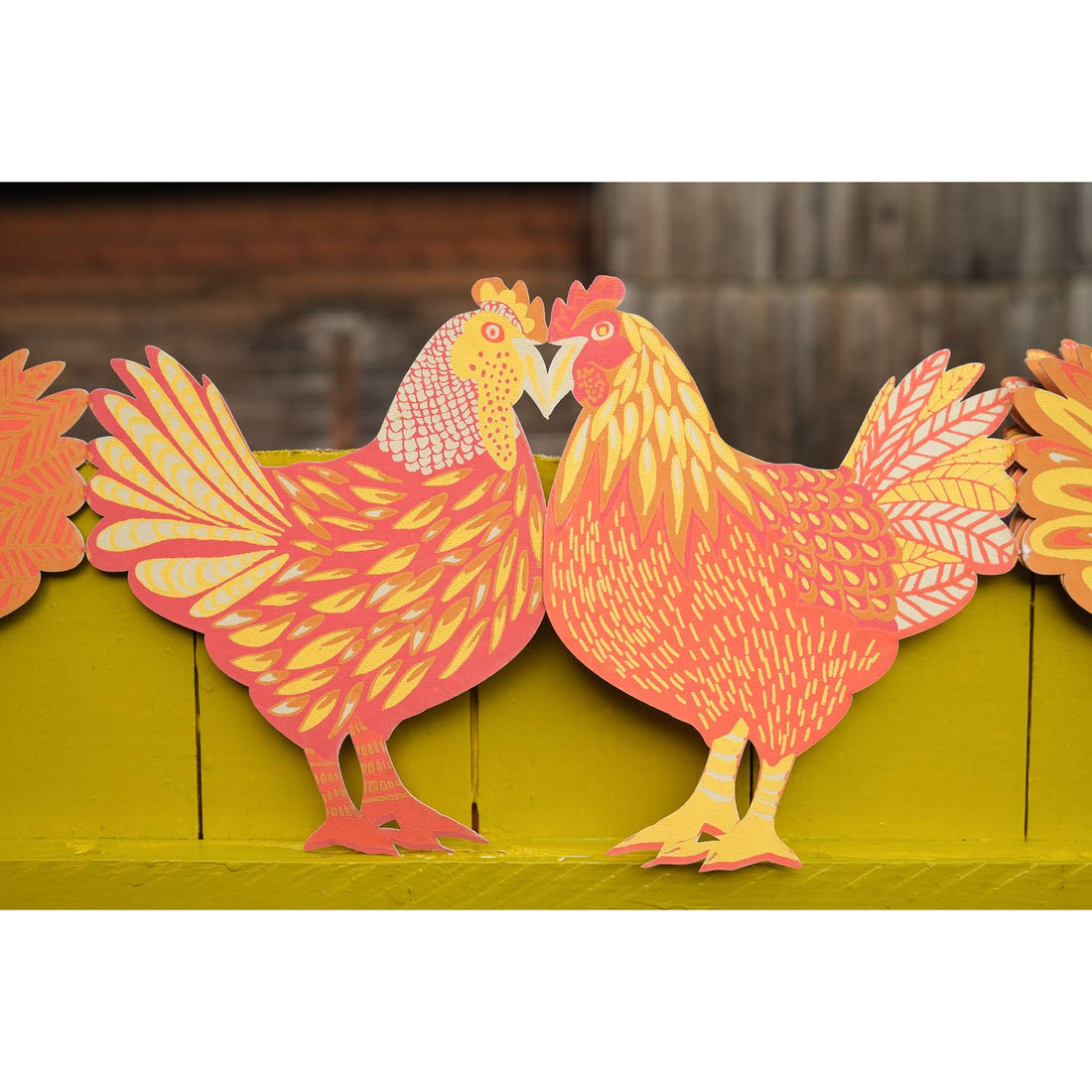 Close up of colorful red &amp; orange hued chicken garland. 