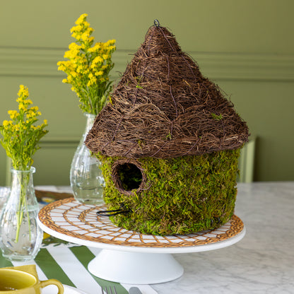 Bungalow Bird House made with moss on a table setting. 