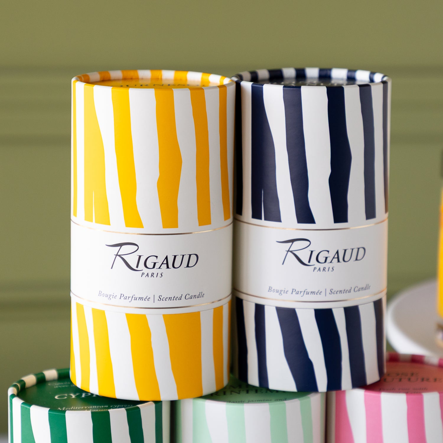 Rigaud 230g candle boxes in a tube shape with colorful stripes.