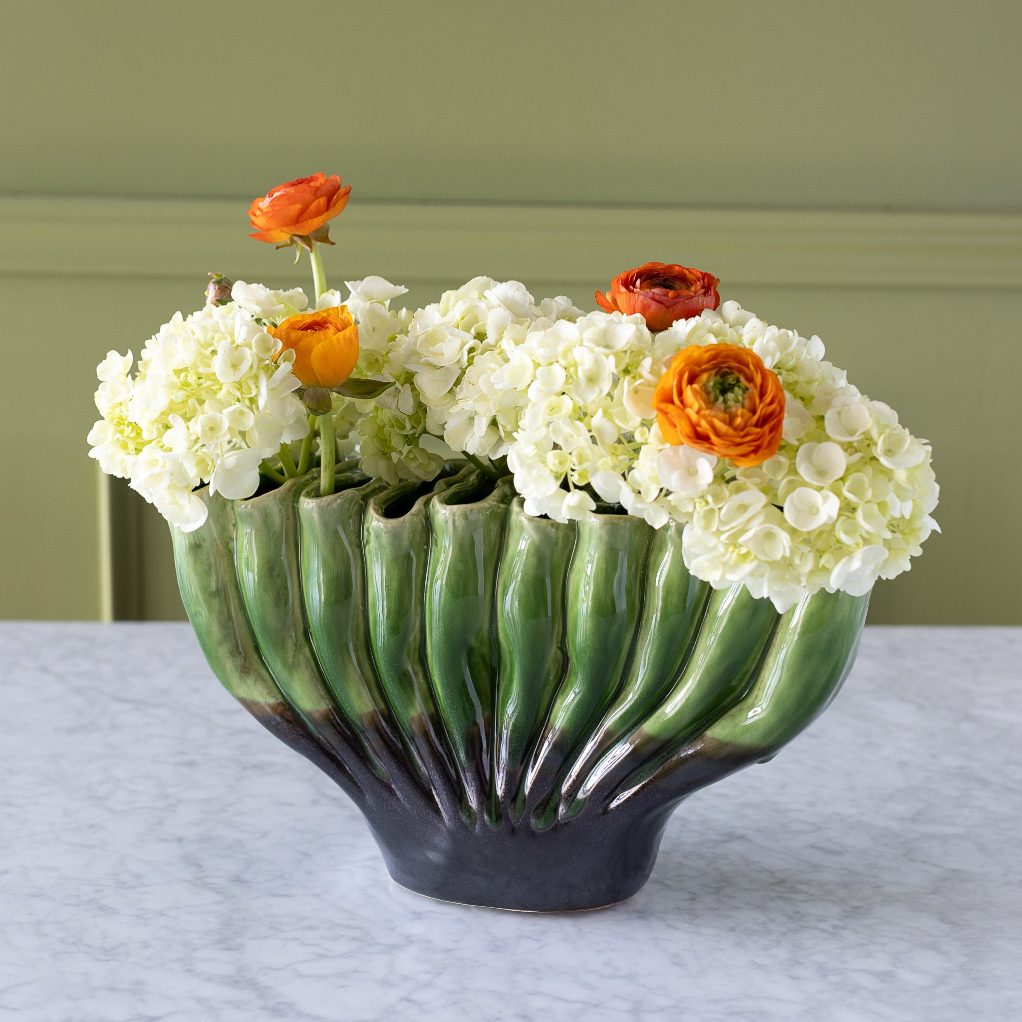 10-hole Ceramic Fakir Green Vase with flowers in it.
