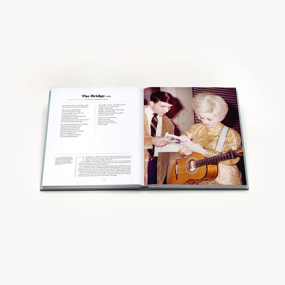 Two hardcover books titled &quot;Songteller: My Life in Lyrics&quot; by Dolly Parton, displayed with the front cover and spine visible, featuring images and text related to Dolly Parton&