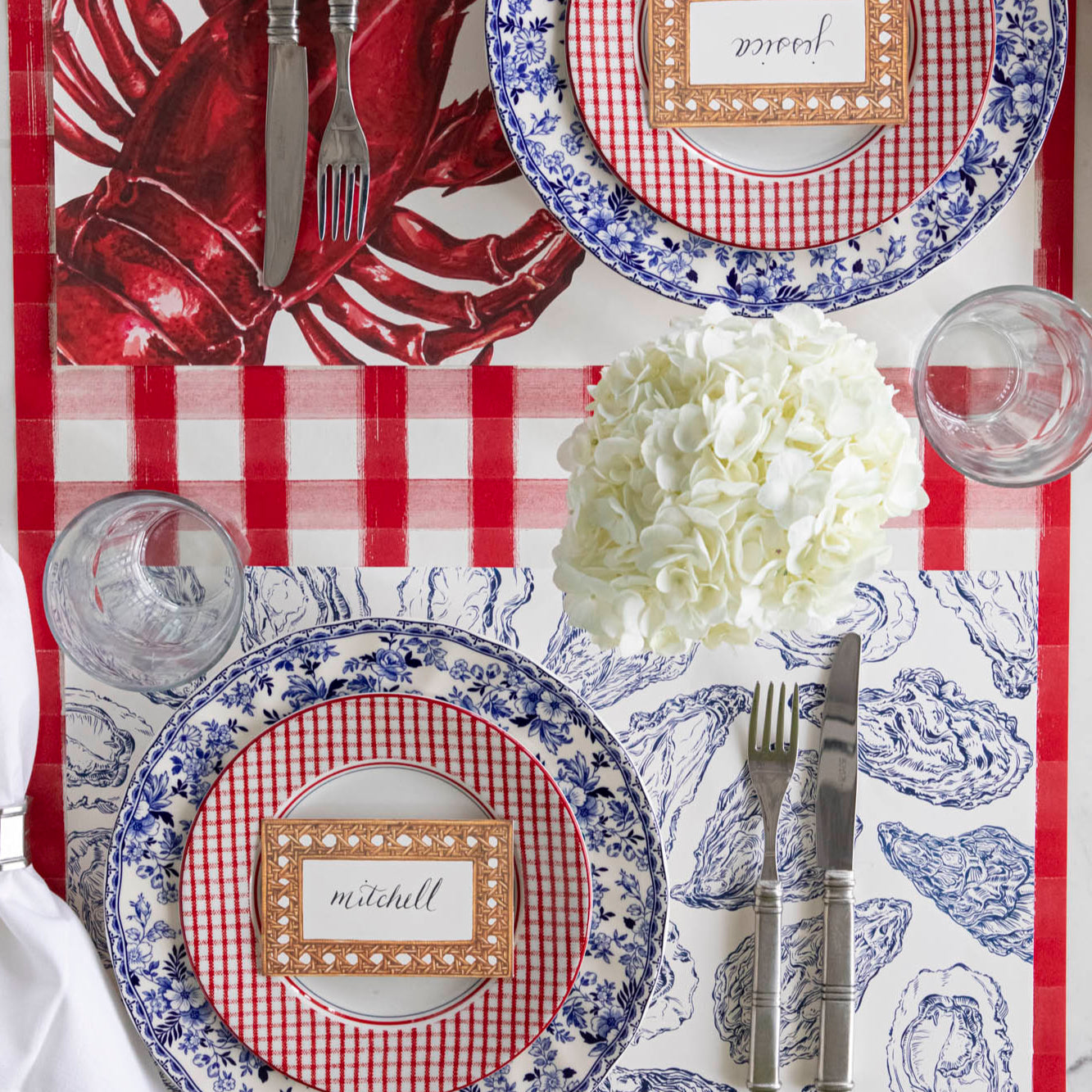 Blue Oyster Placemat under an elegant place setting paired with the Lobster Placemat.