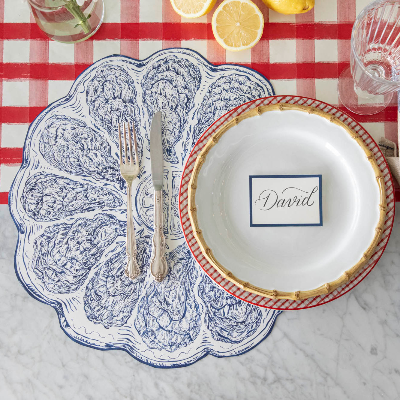Die-cut Blue Oyster Plate Placemat styled on a summer place setting.