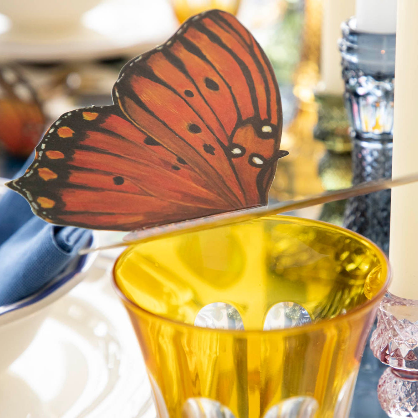 Butterfly Table Accent perched on a glass.